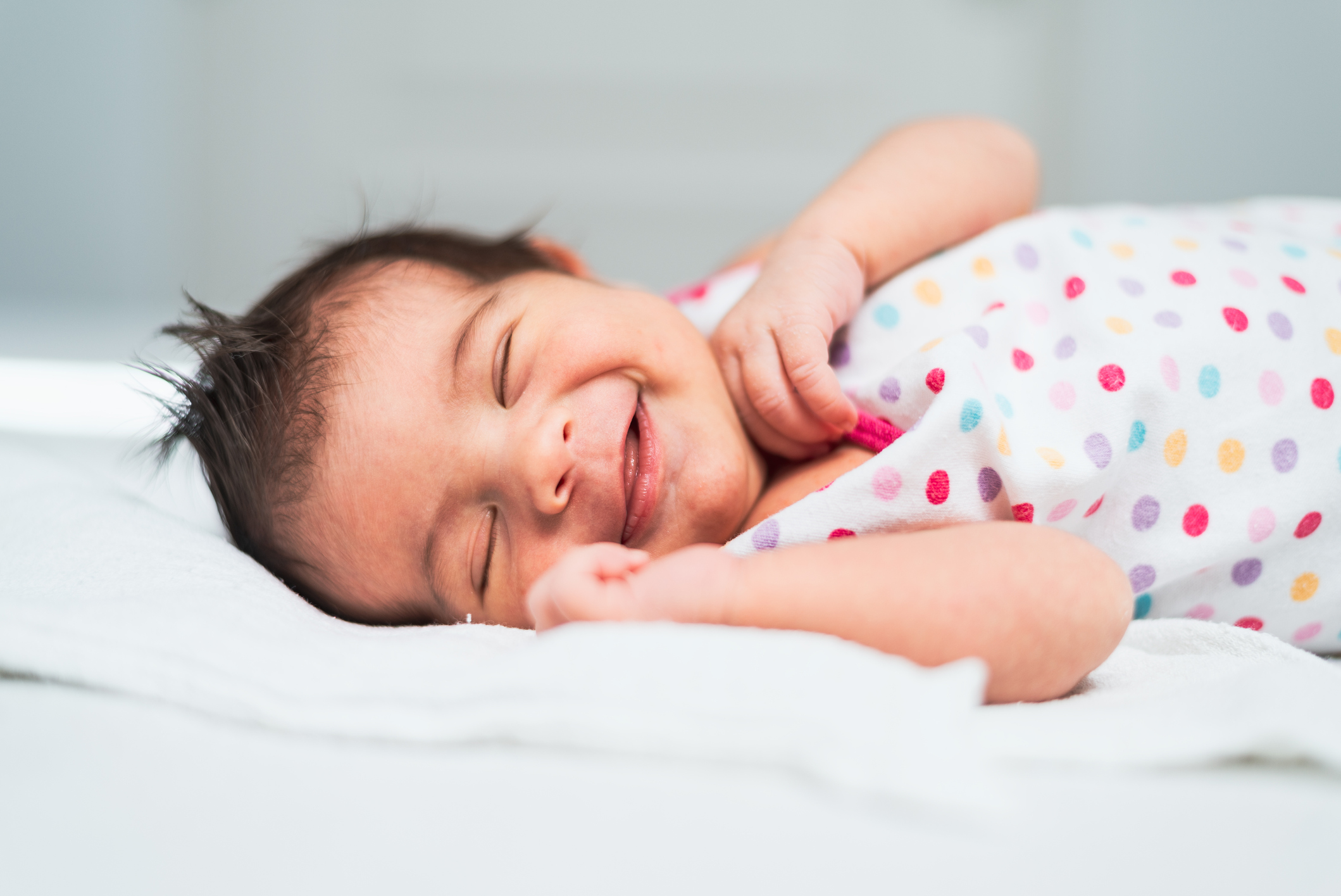 Smiling newborn baby girl