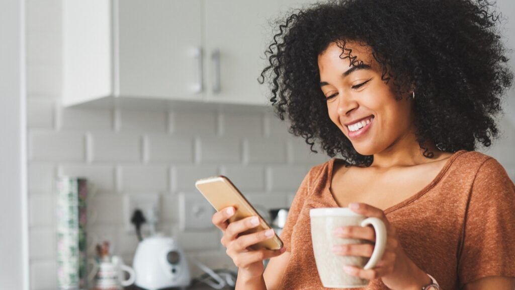 Black woman looking at phone