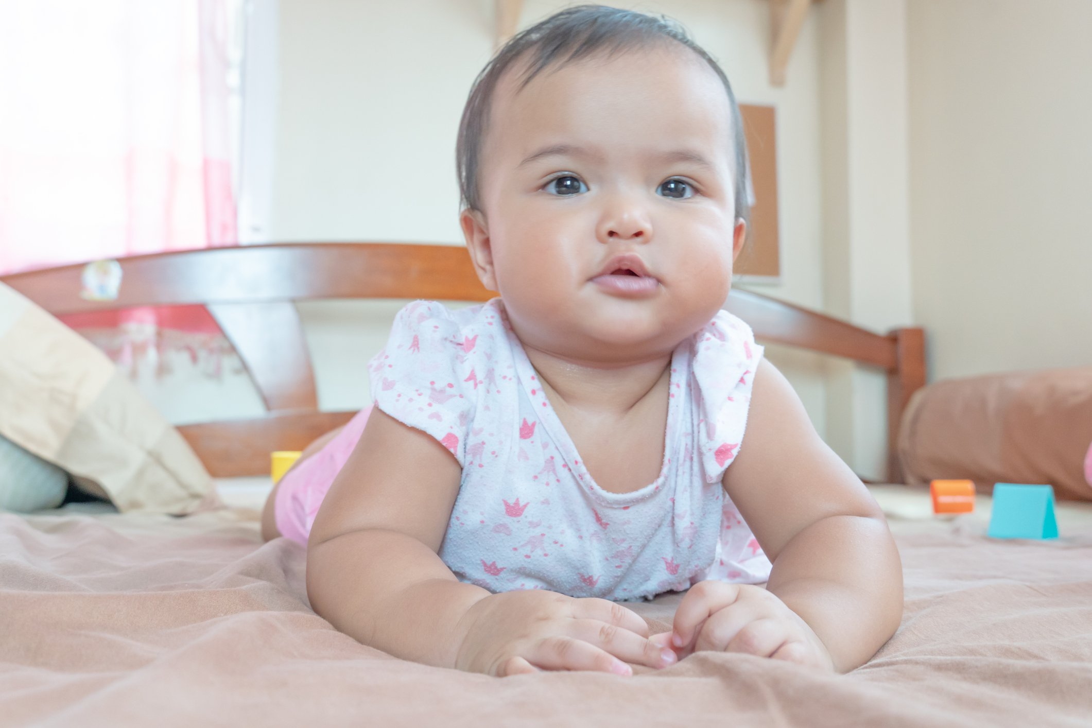 Asian baby girl lying down on the bed