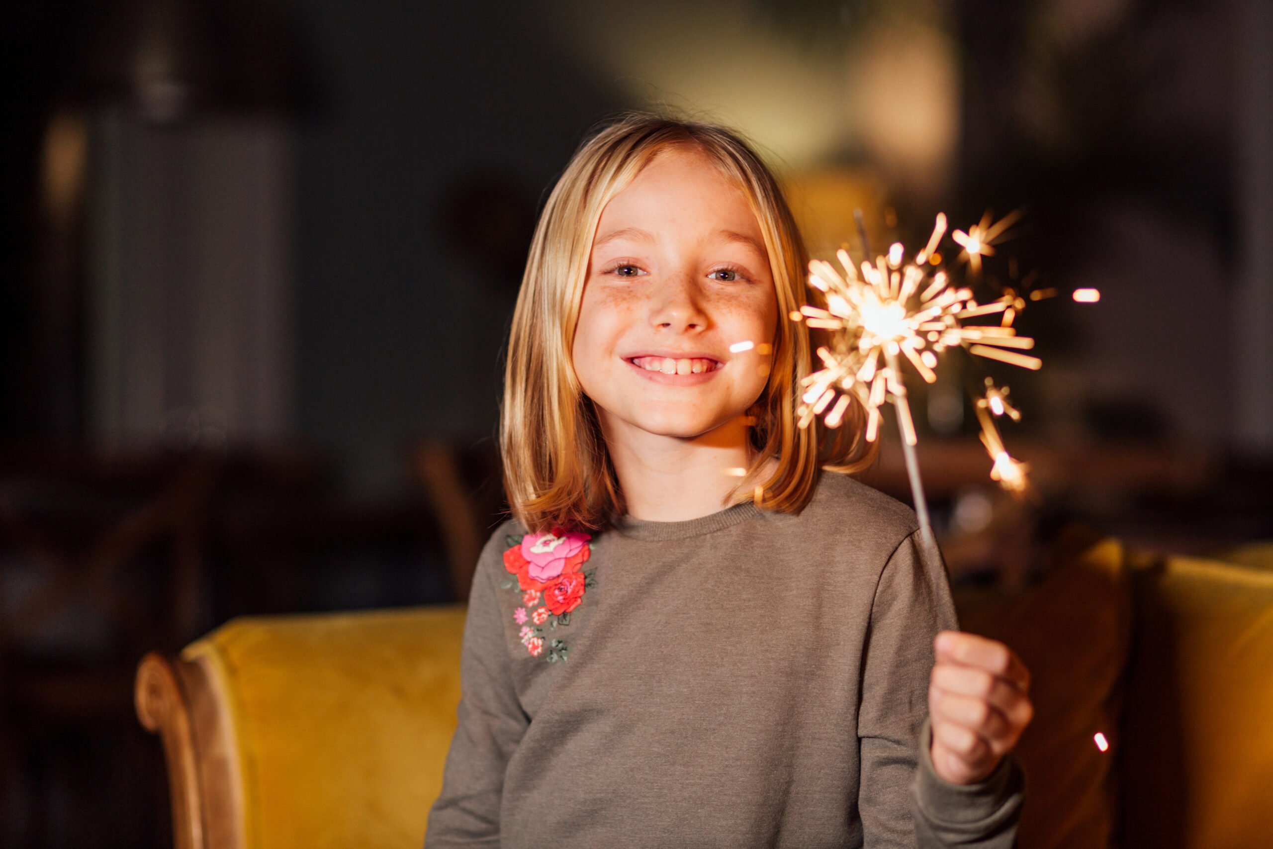 girl holding sparkler