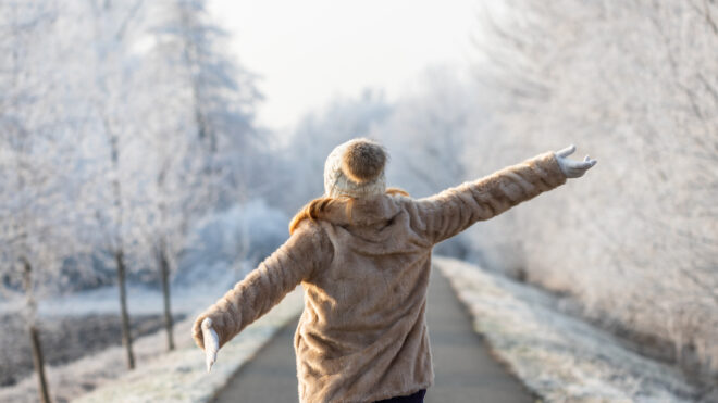 A woman walking outside in the snow