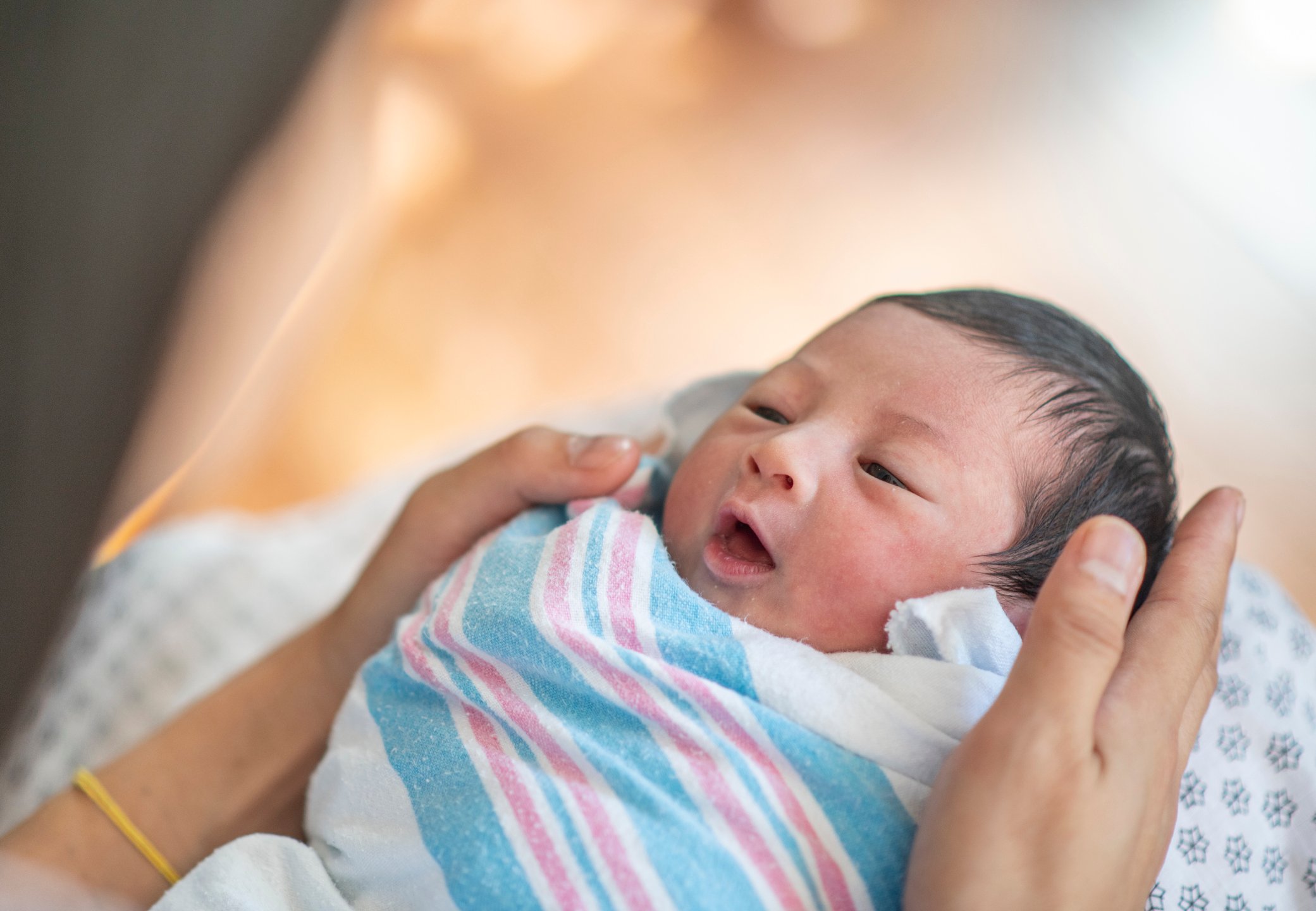 Swaddled Newborn Baby and Mother stock photo