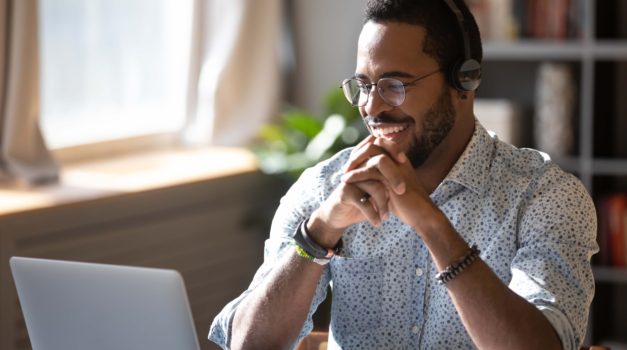 Smiling biracial businessman holding video call with clients partners.
