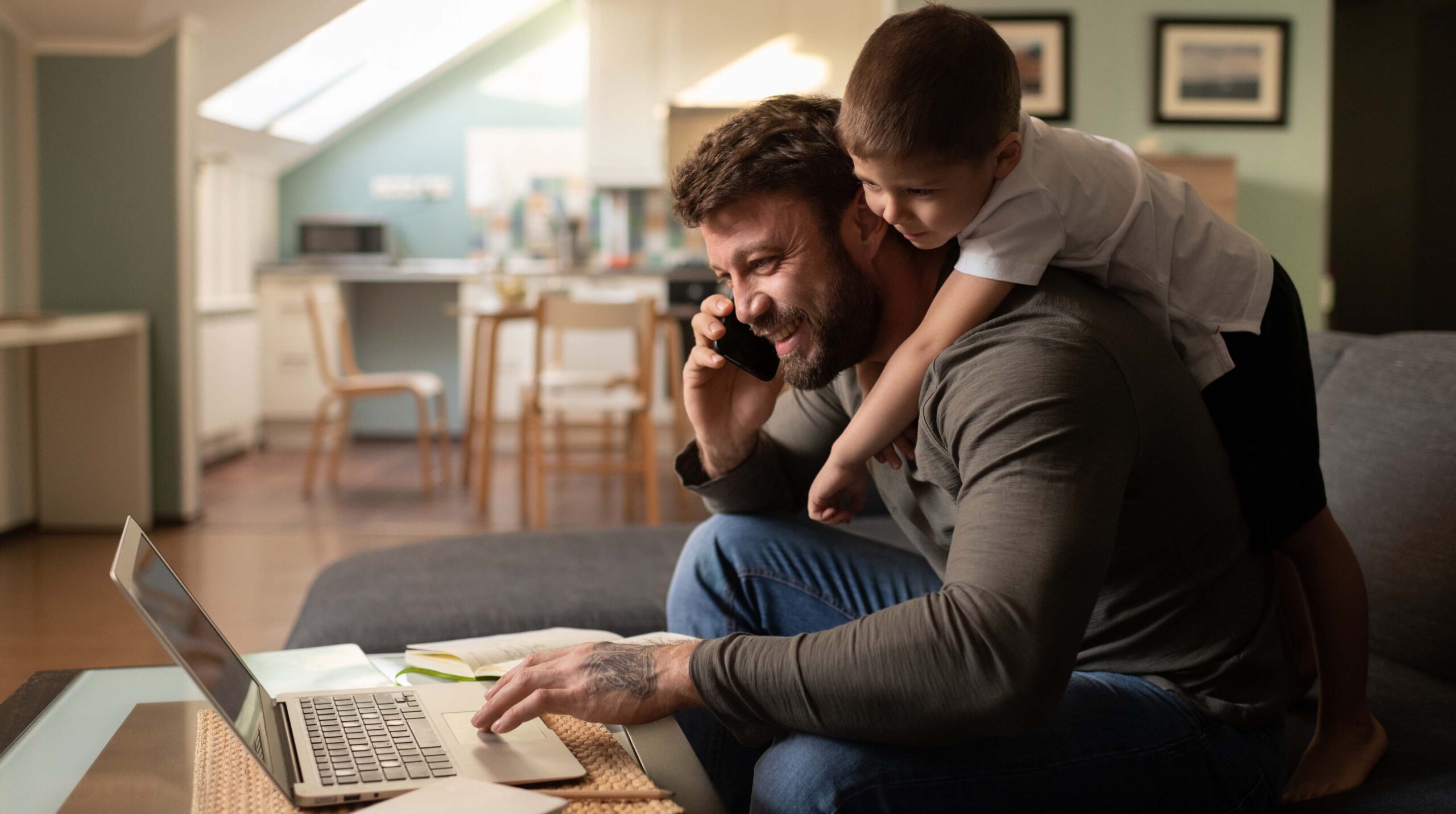 Cheerful father with son working from home