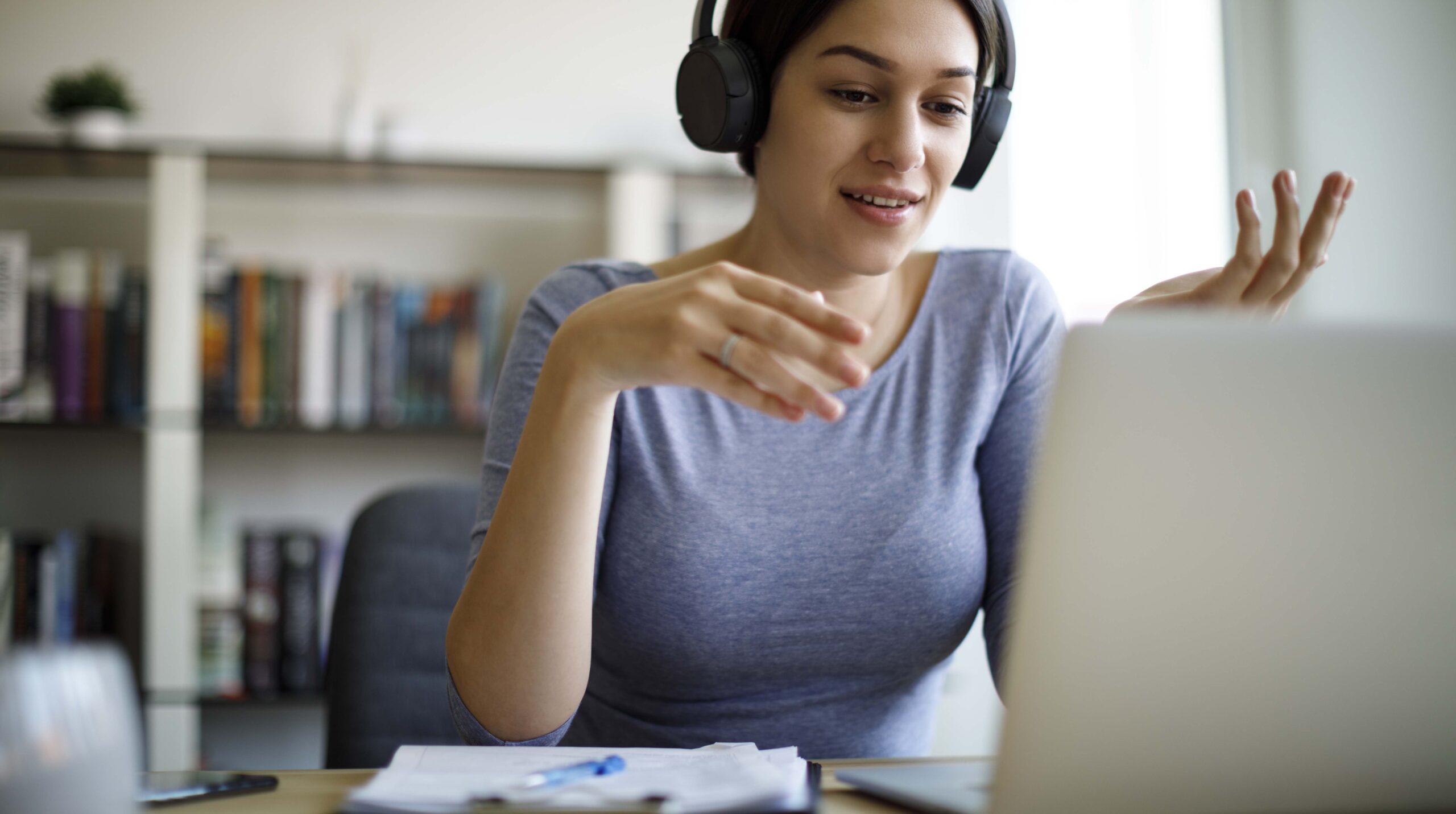 Young woman having video call on laptop computer at home