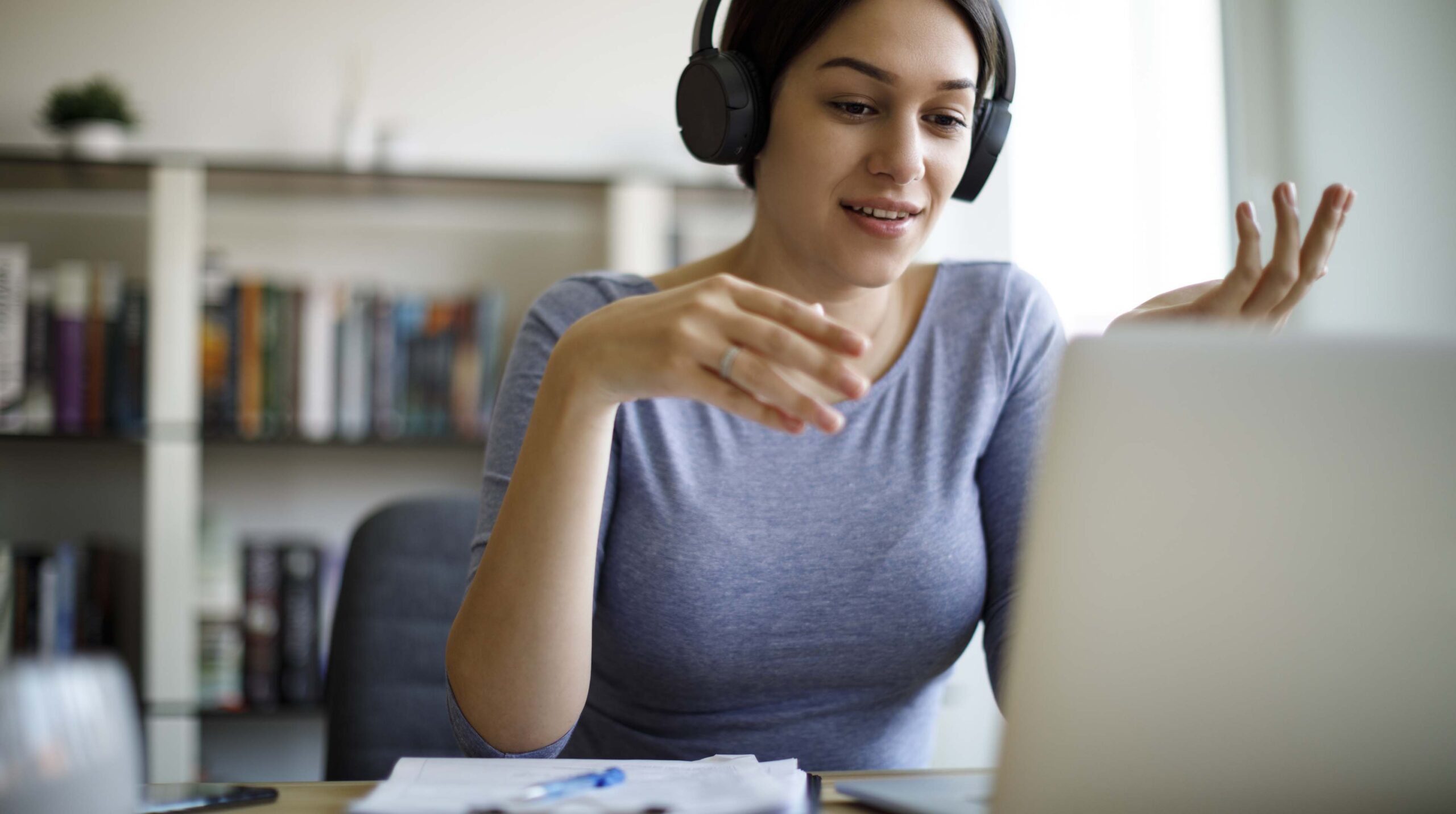 Young woman having video call on laptop computer at home
