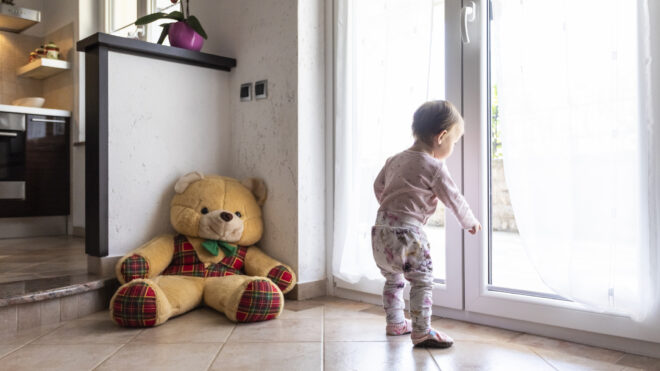 A kid looking out the door