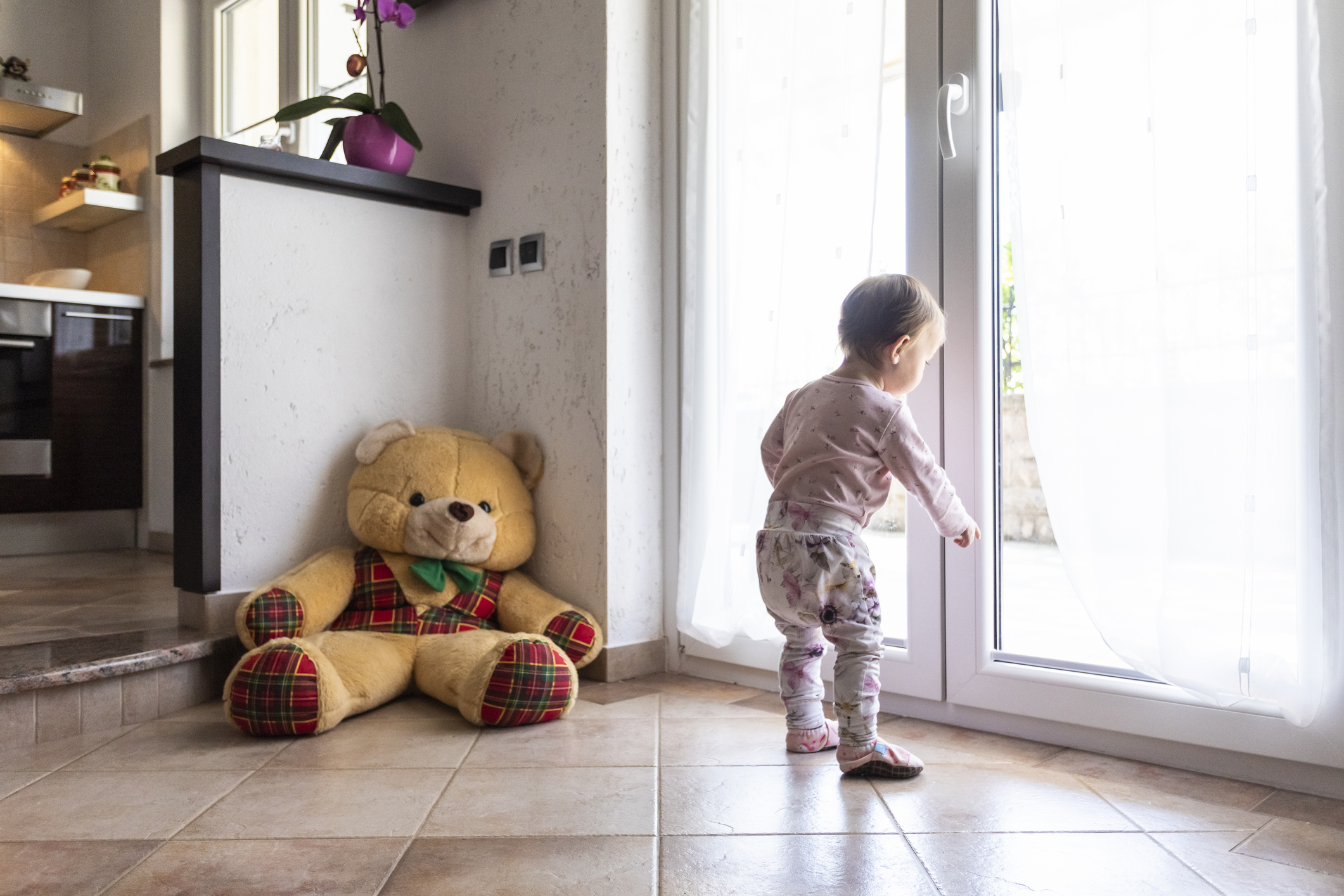 A kid looking out the door