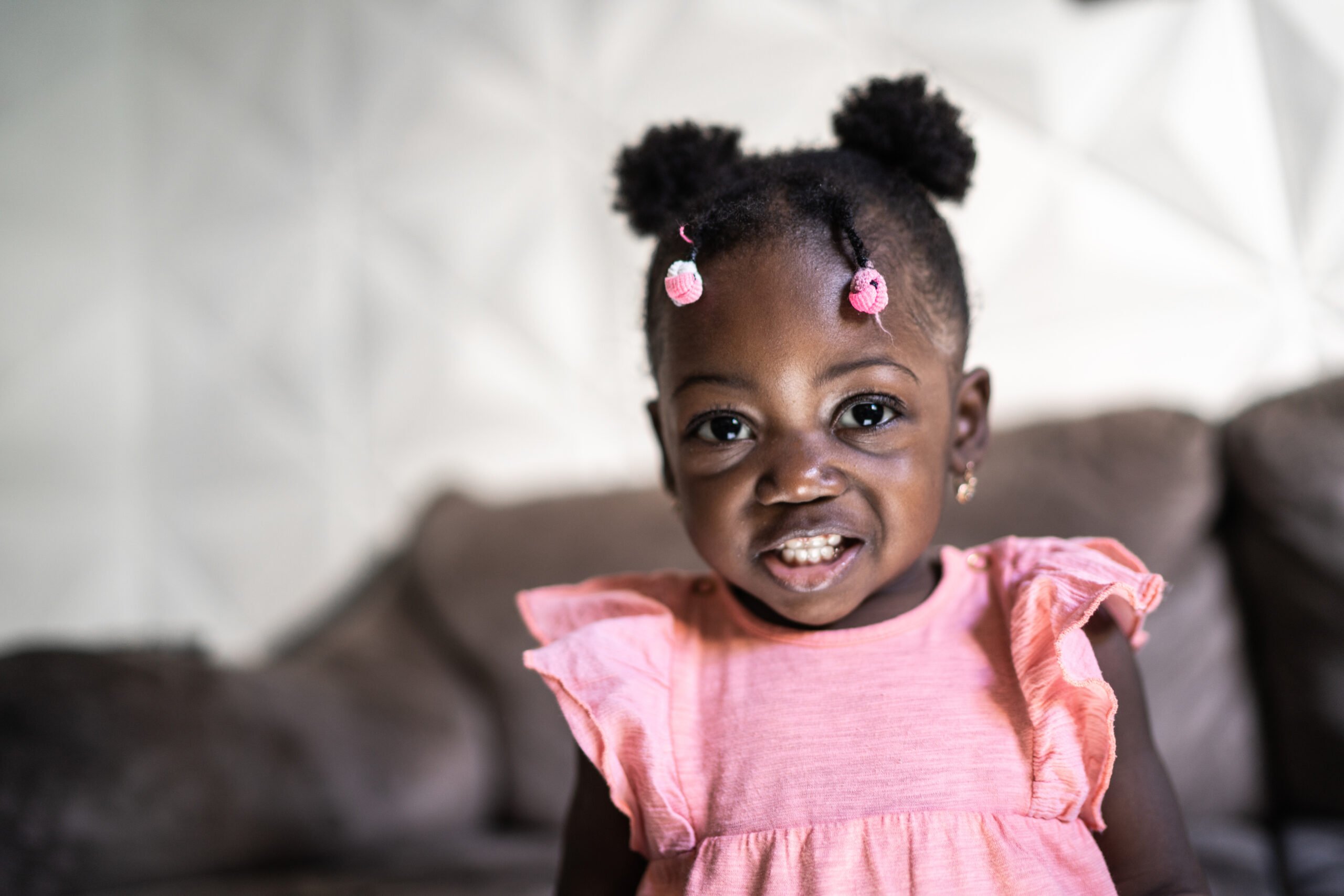 Portrait of a cute baby girl smiling at home