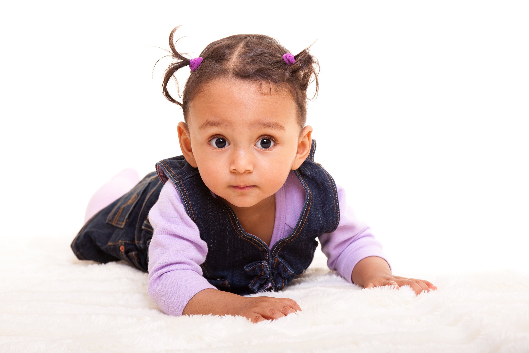 Beautiful biracial baby girl lying on the floor