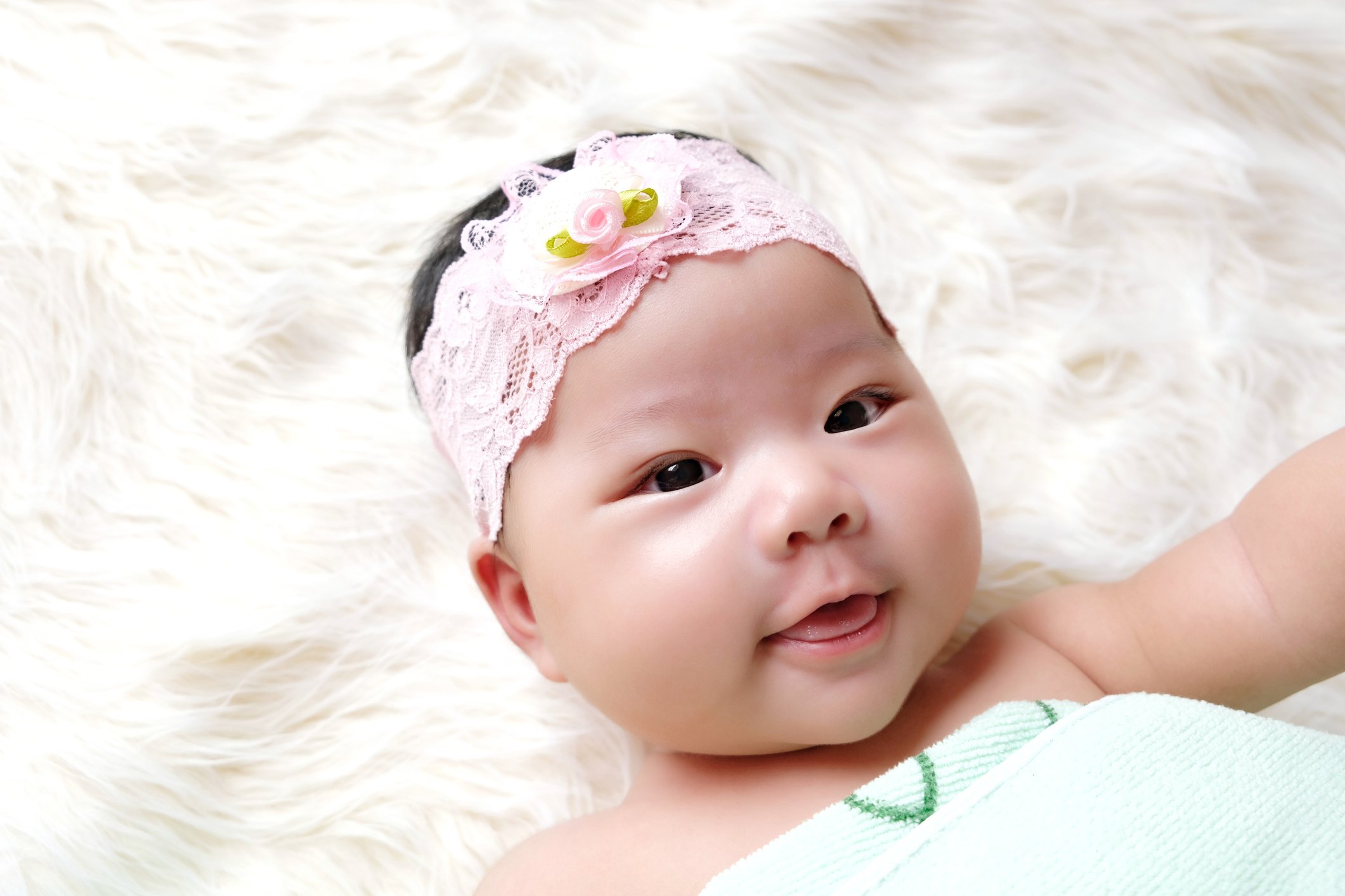 Cute newborn baby sleep on white fabric background.