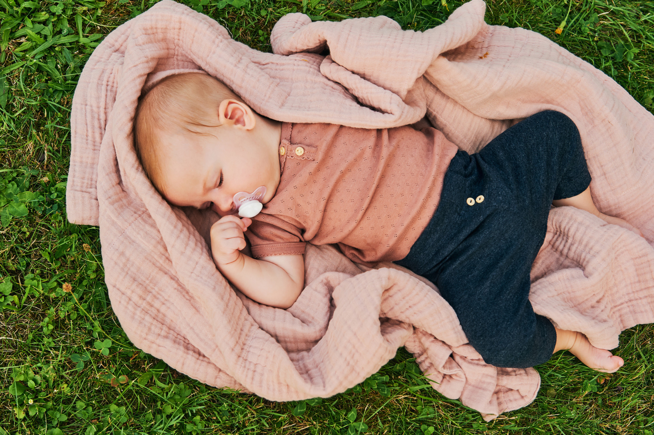 baby laying in grass