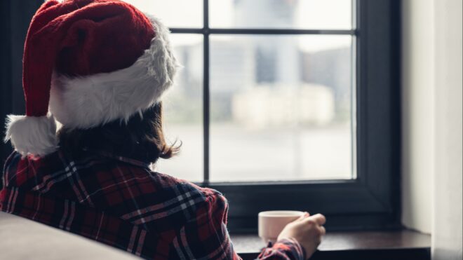 A woman looking outside of a window