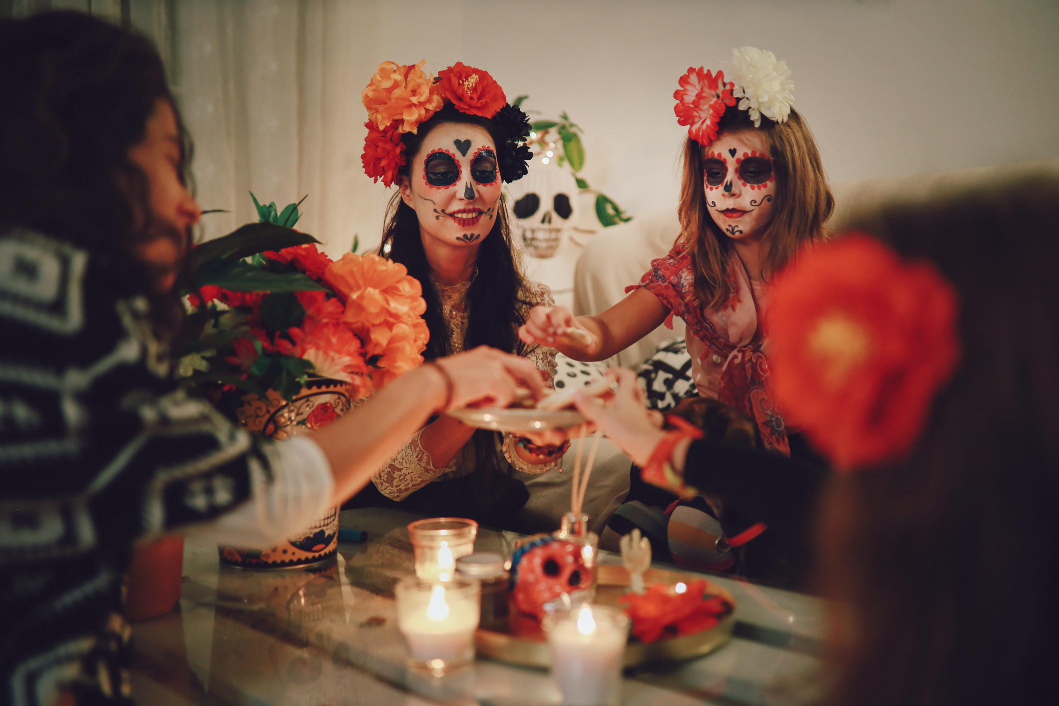Mom celebrating Day of the dead with her daughter at home