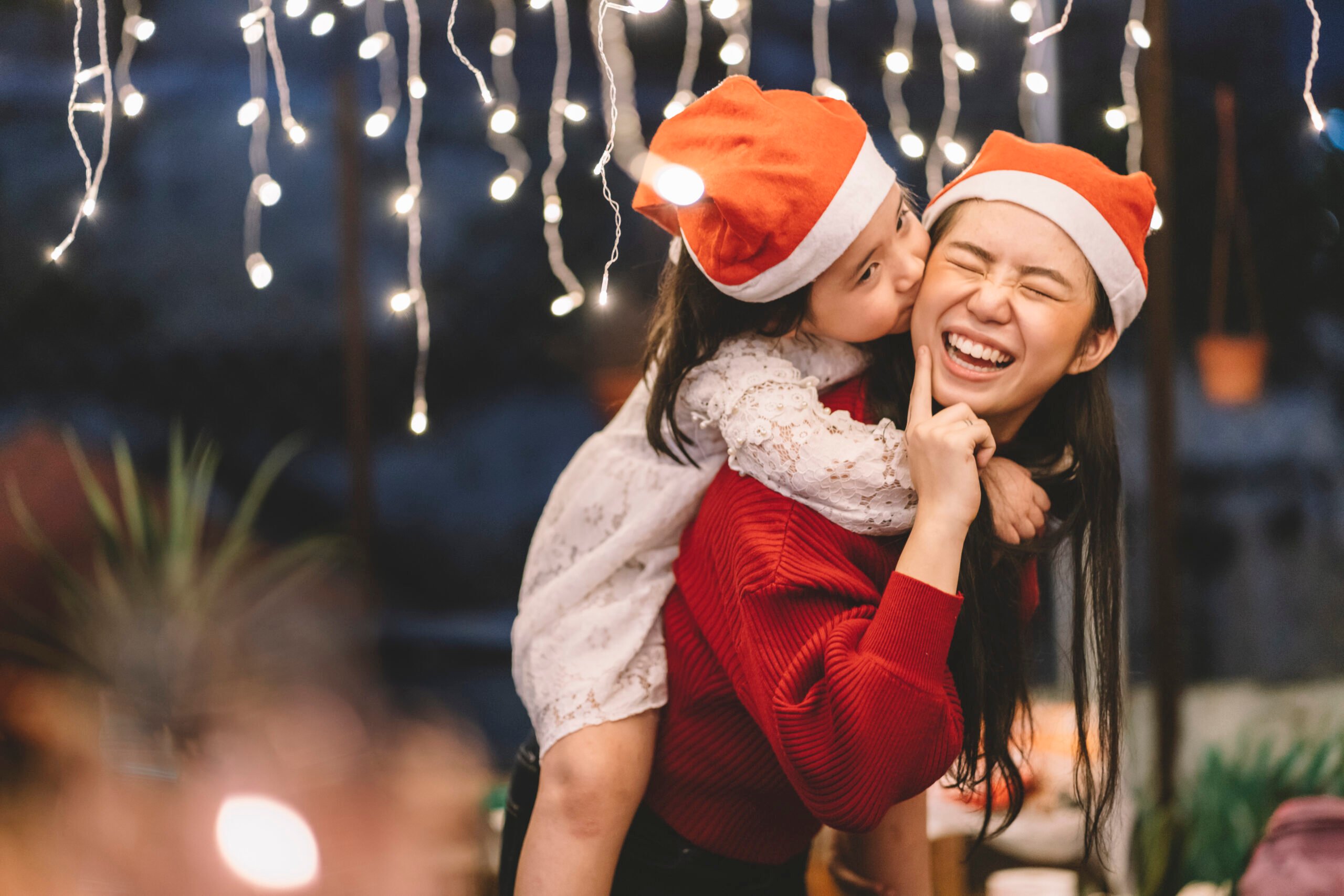 mom piggyback girl santa hats