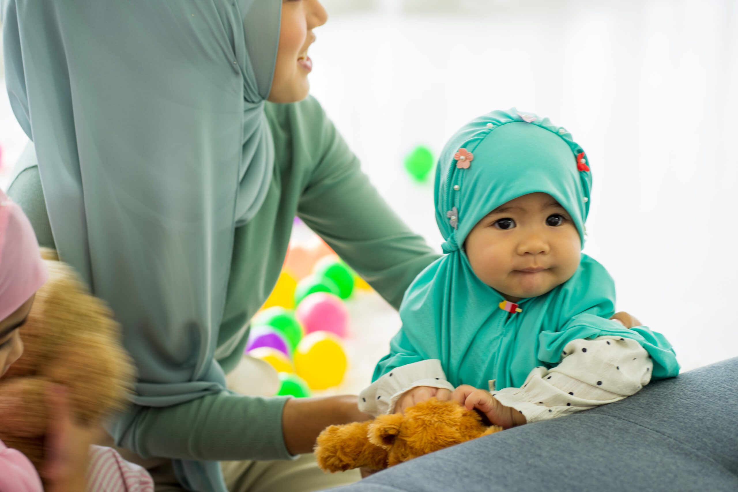 Muslim asian mother and business woman work from home and caring for newborn infant wearing HIJAB work from home new normal