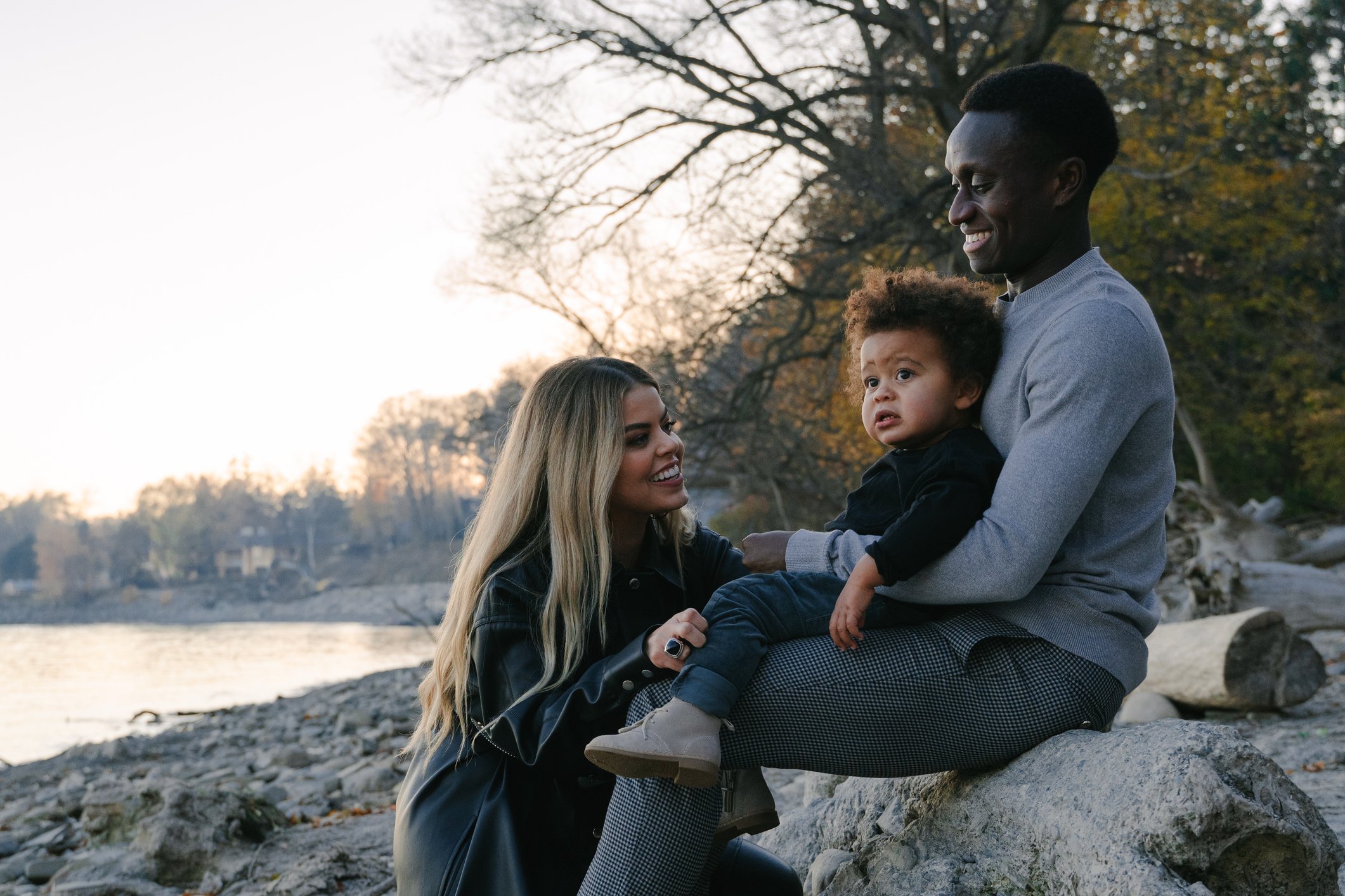 Mixed race family enjoy time together by the water