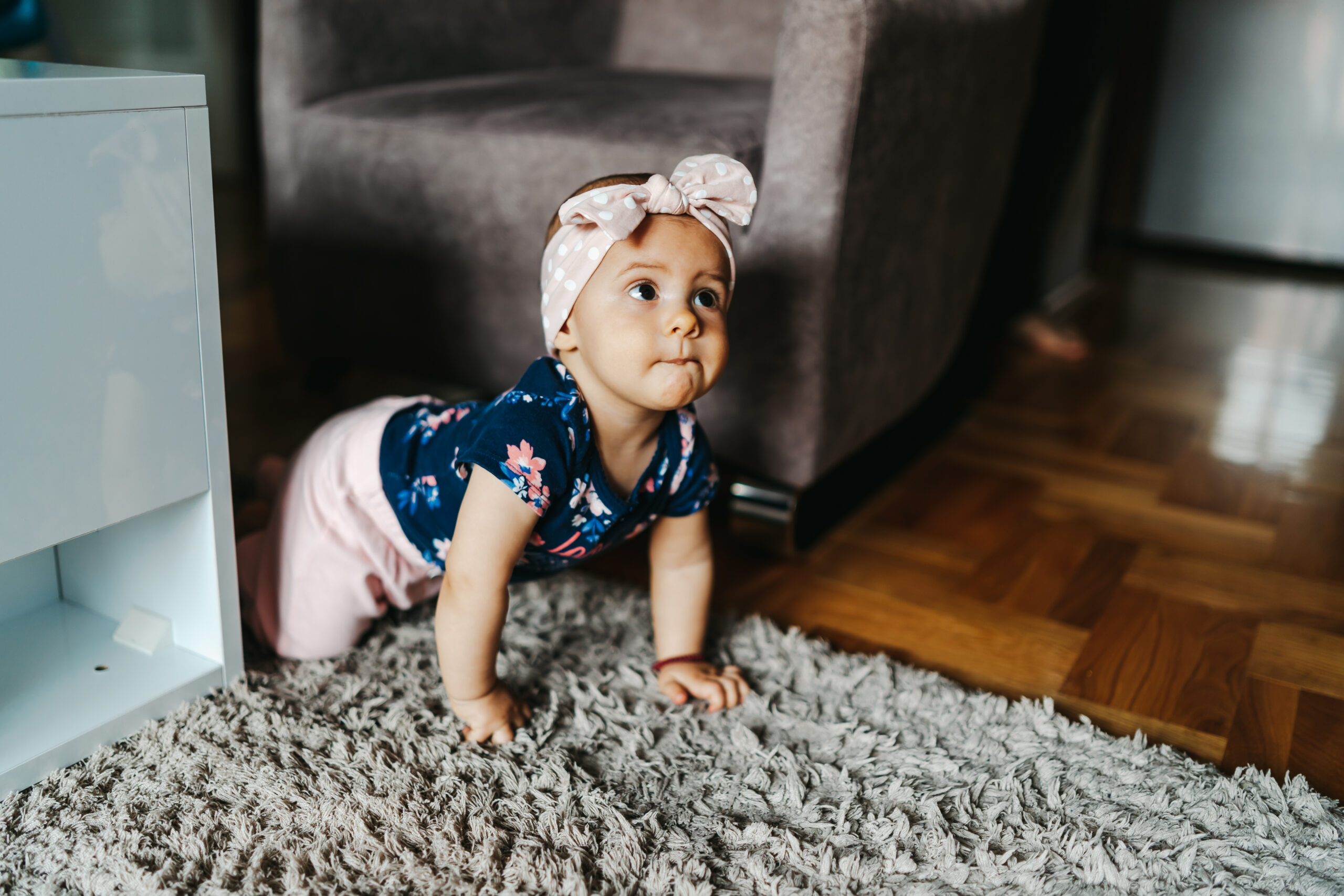 Baby girl crawling on floor
