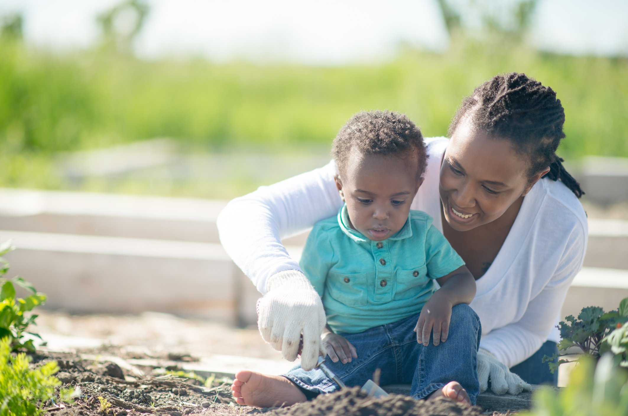 Mother and son gardening outdoors
