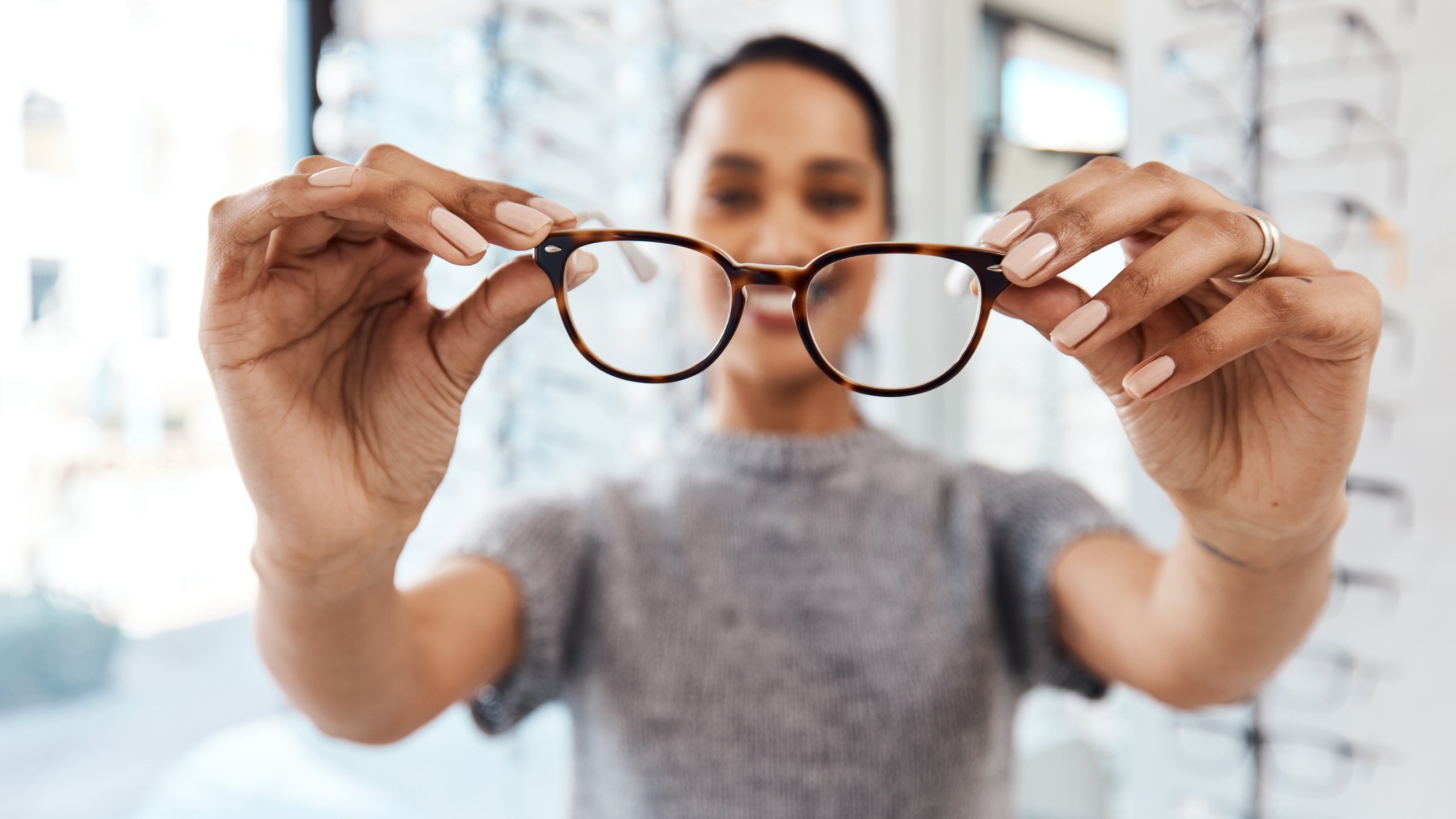 A woman putting glasses on someone