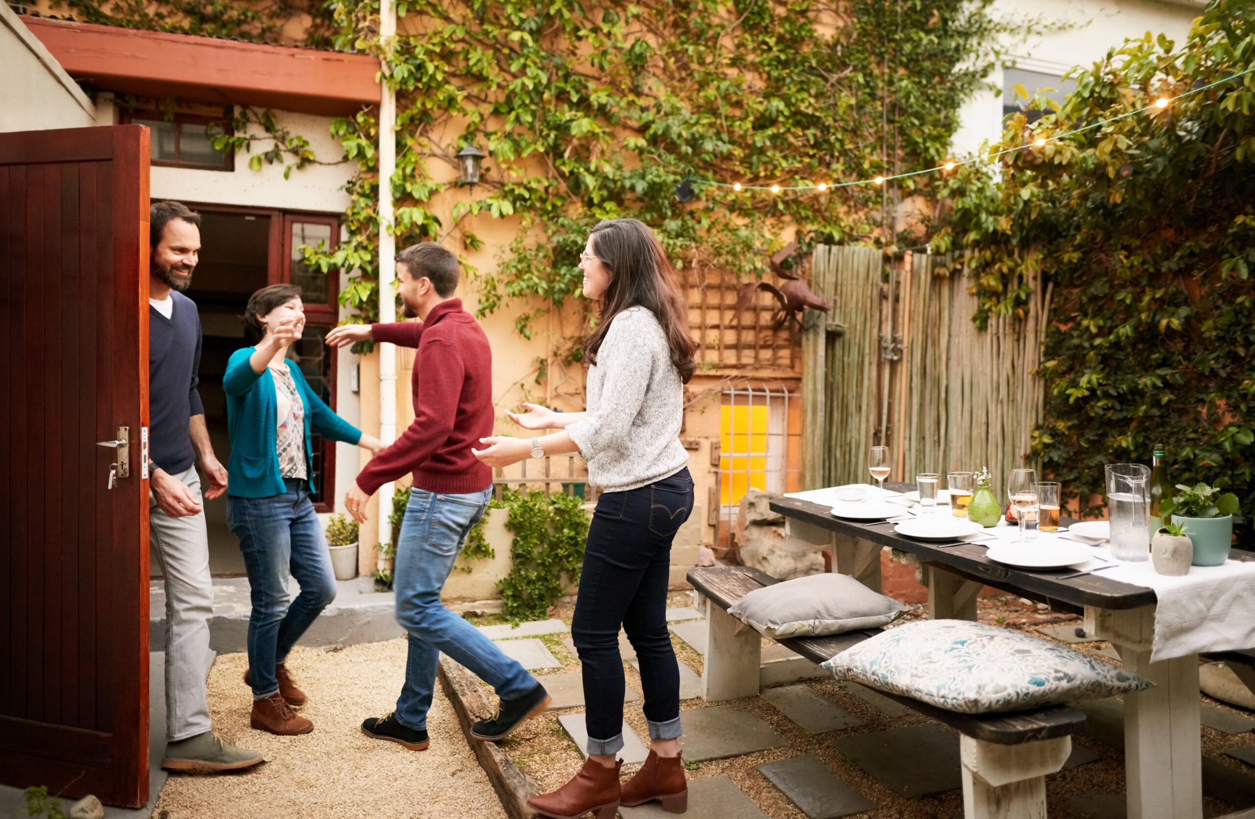 Couple welcoming guests for party