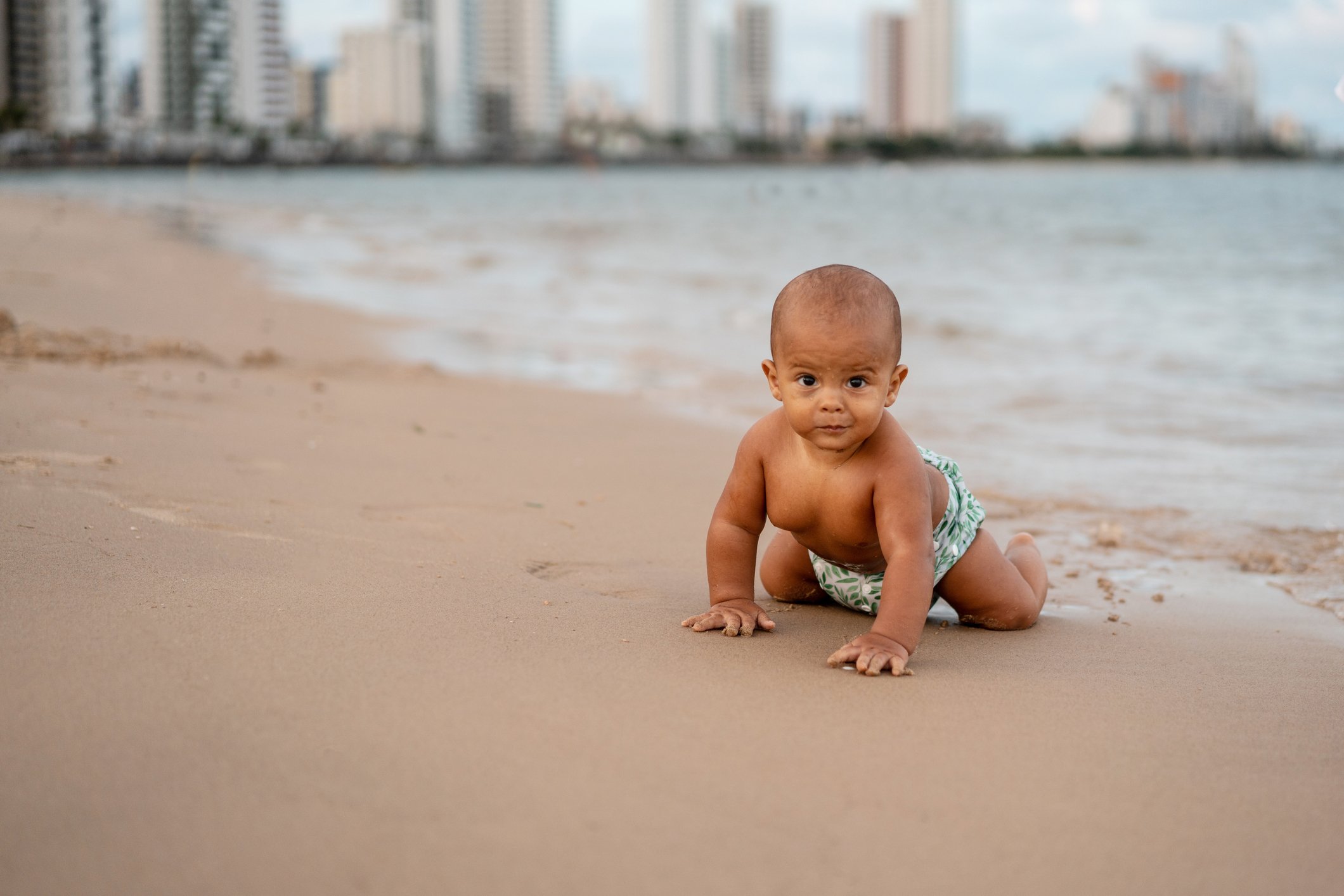 Baby crawling on the shore