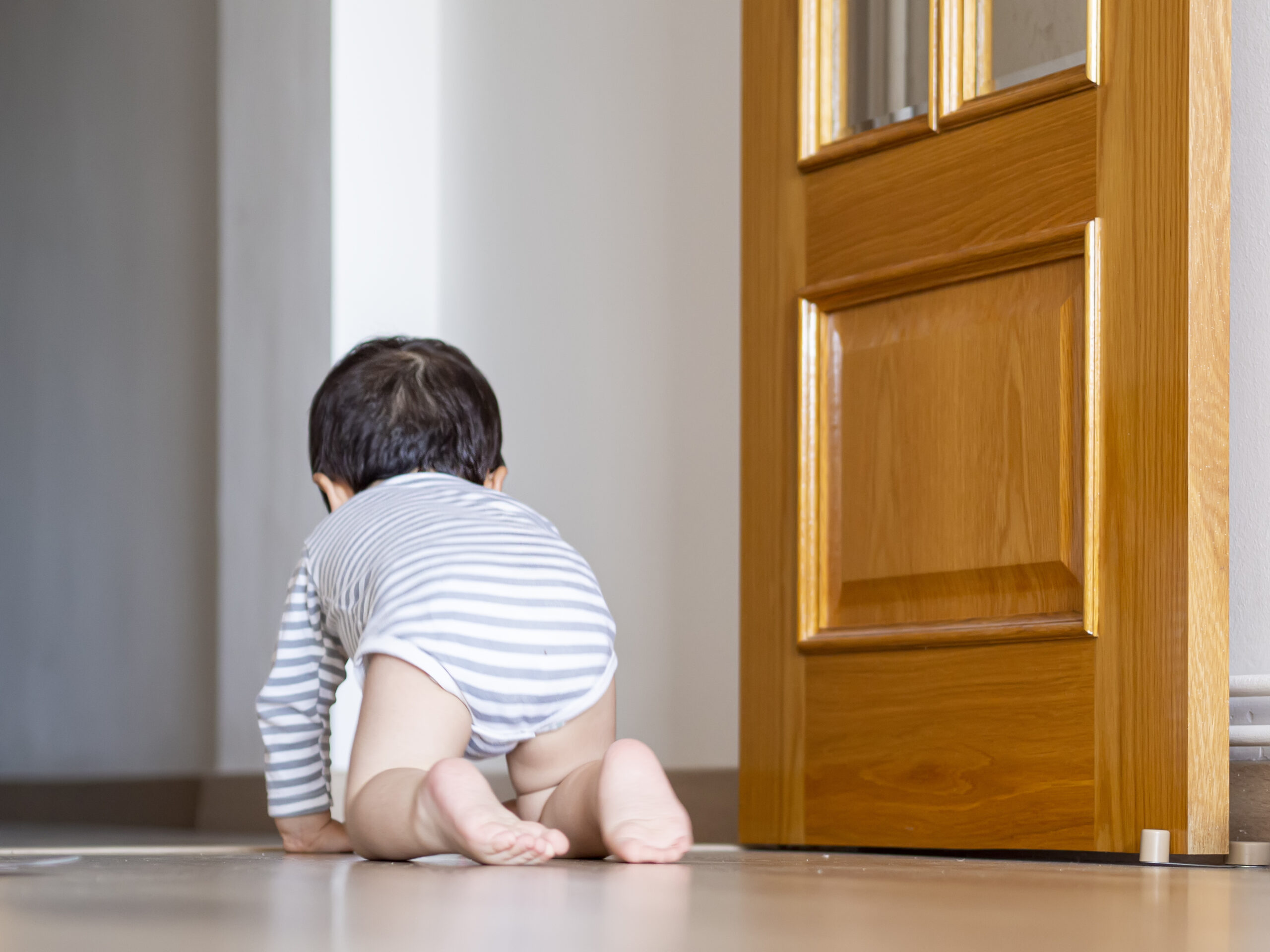 Baby boy crawling at home and learning how to crawl.