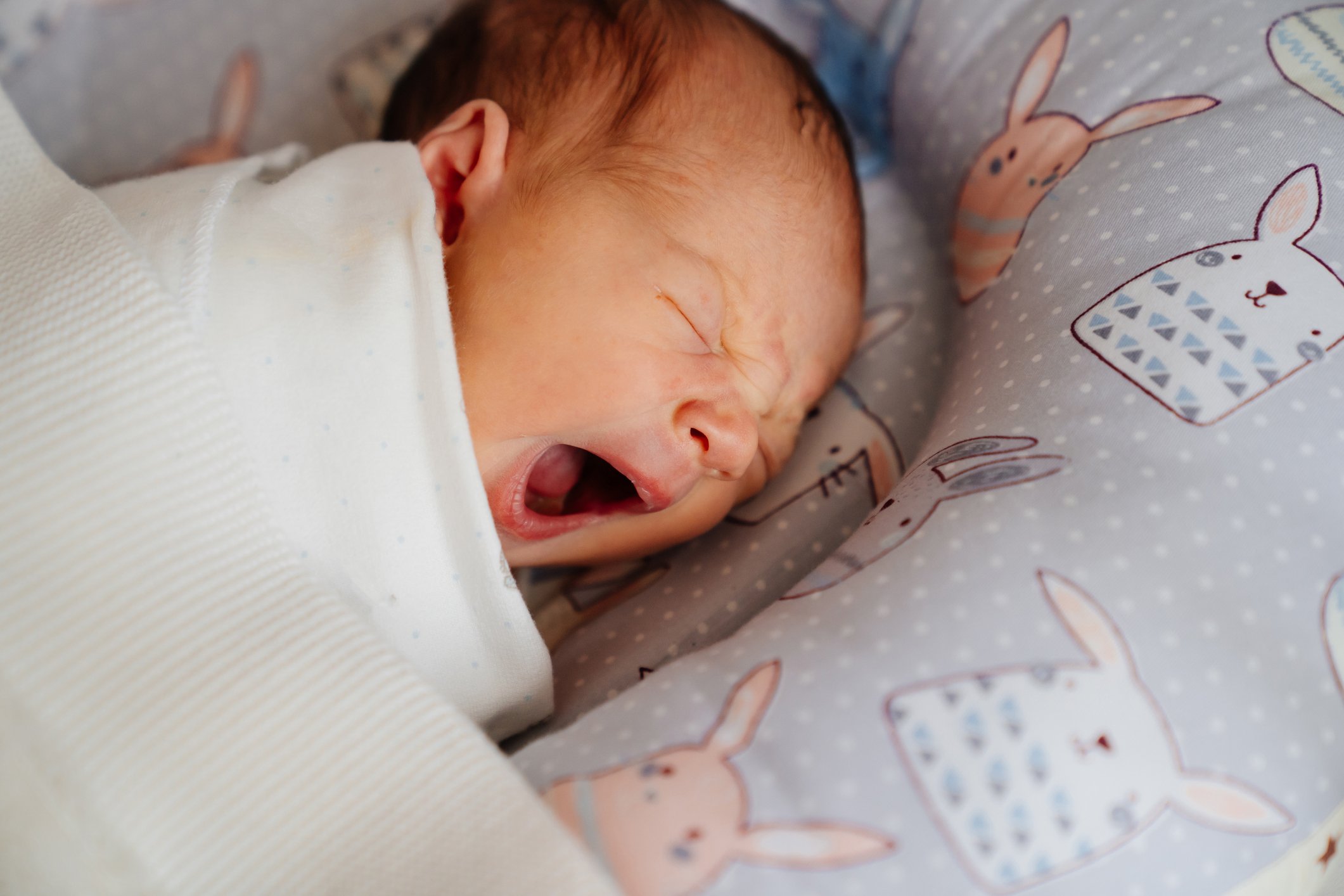 The newborn baby sleeps and yawns. healthy children's sleep.
