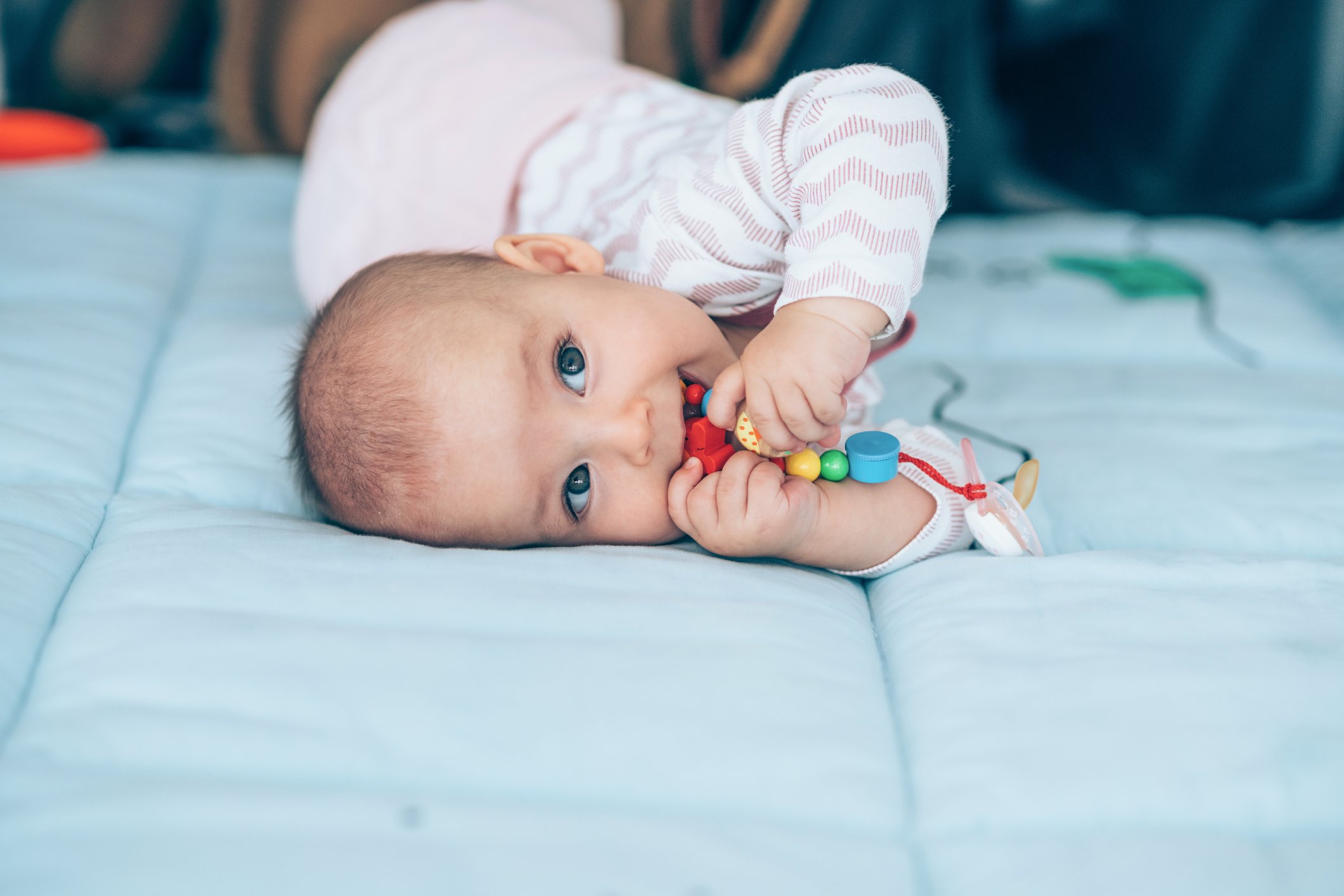 Smiling baby girl lying on the floor.