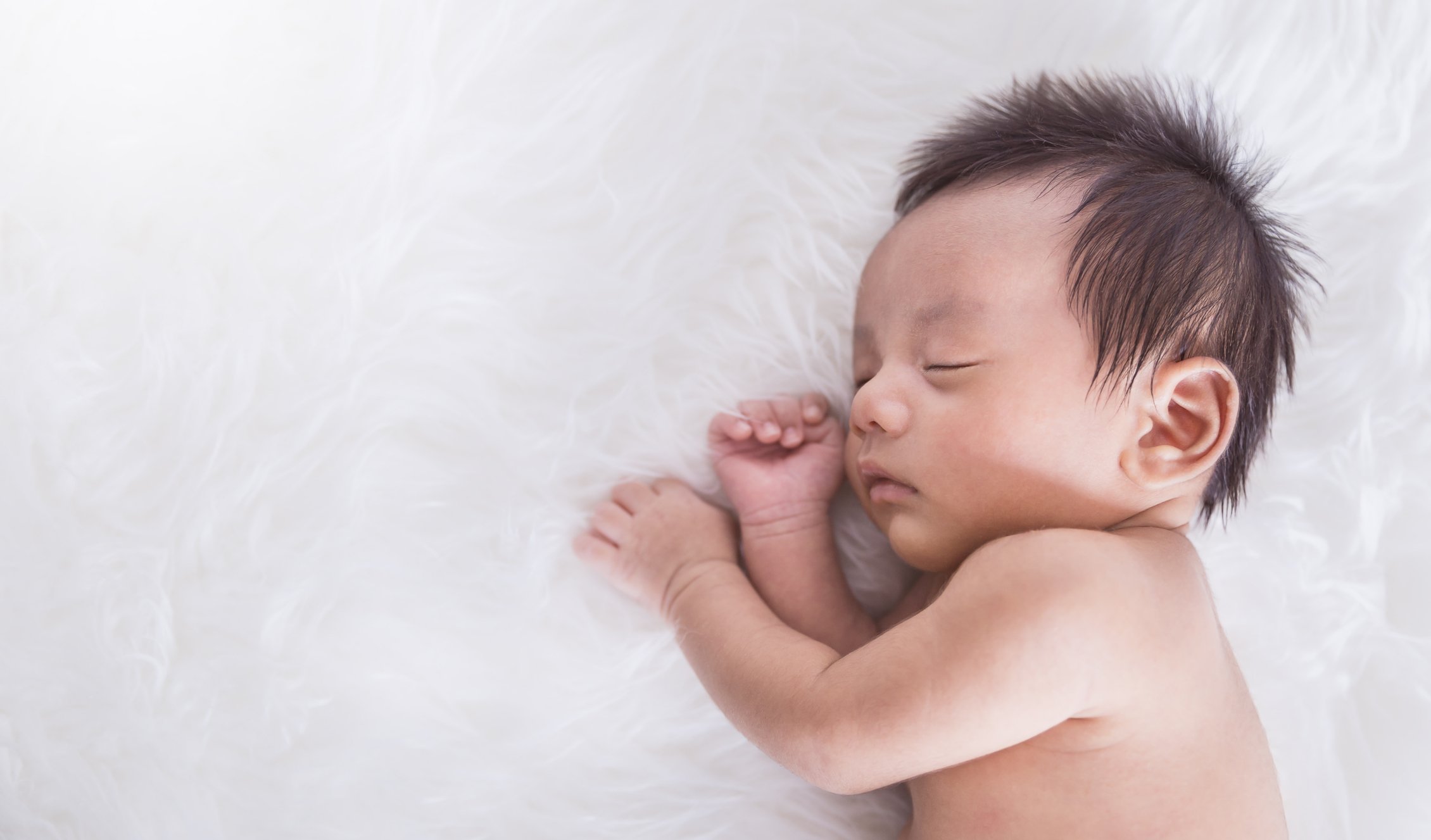 Closeup portrait of sleeping asian happy newborn baby over white background, Family life love newborn healthcare medical concept.