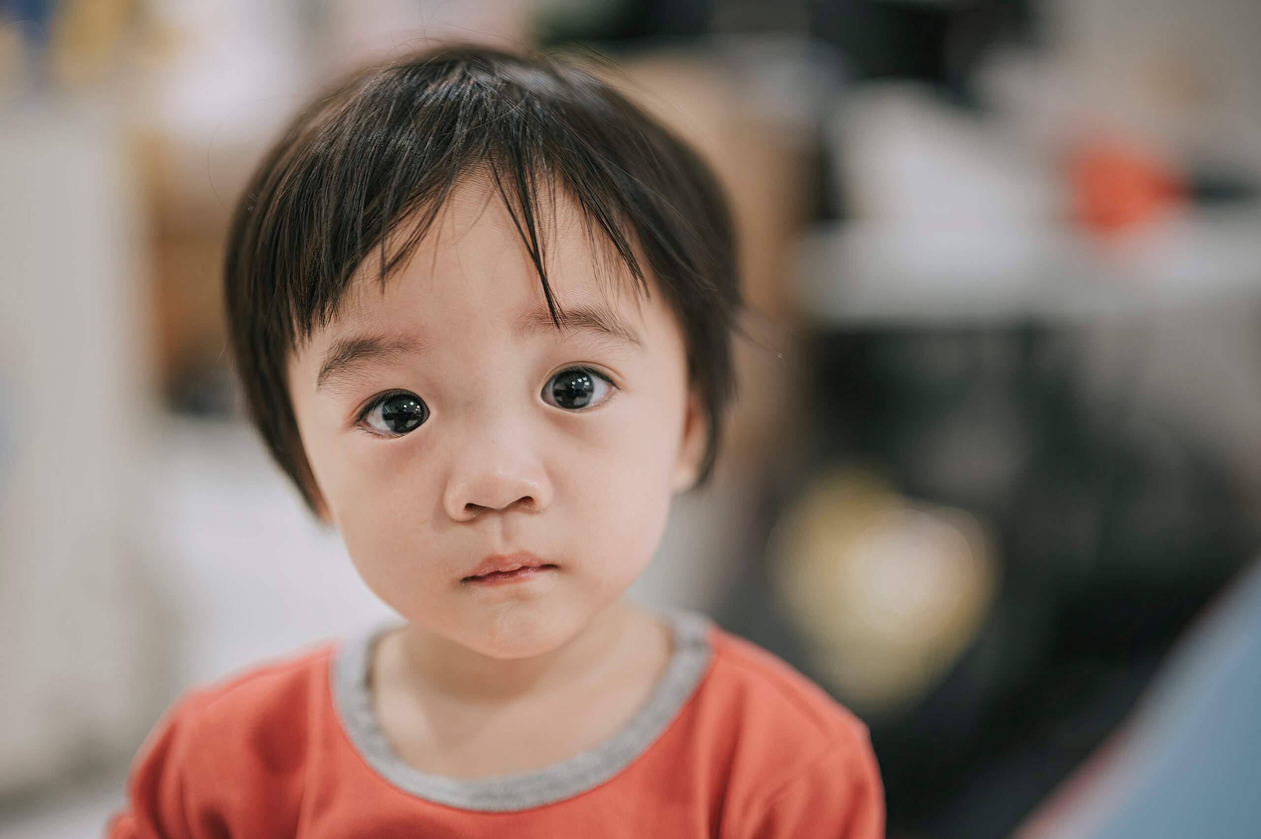 Asian chinese baby boy looking at camera curiously