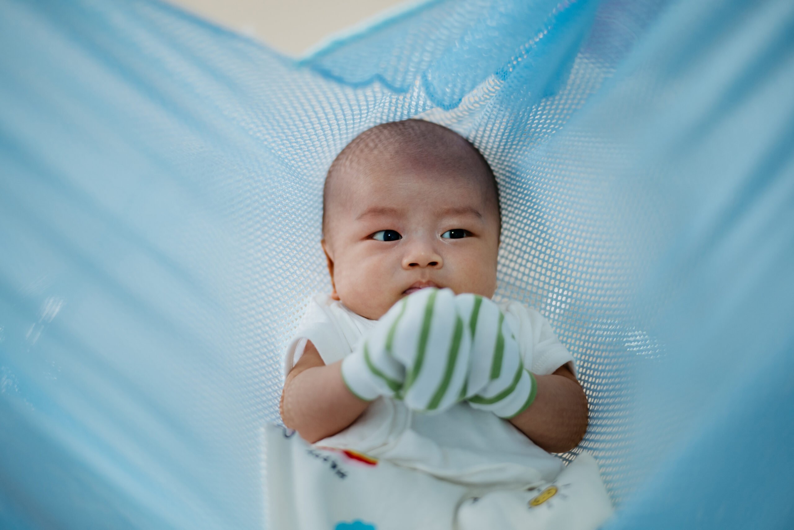 Asian baby boy sleeping in cradle
