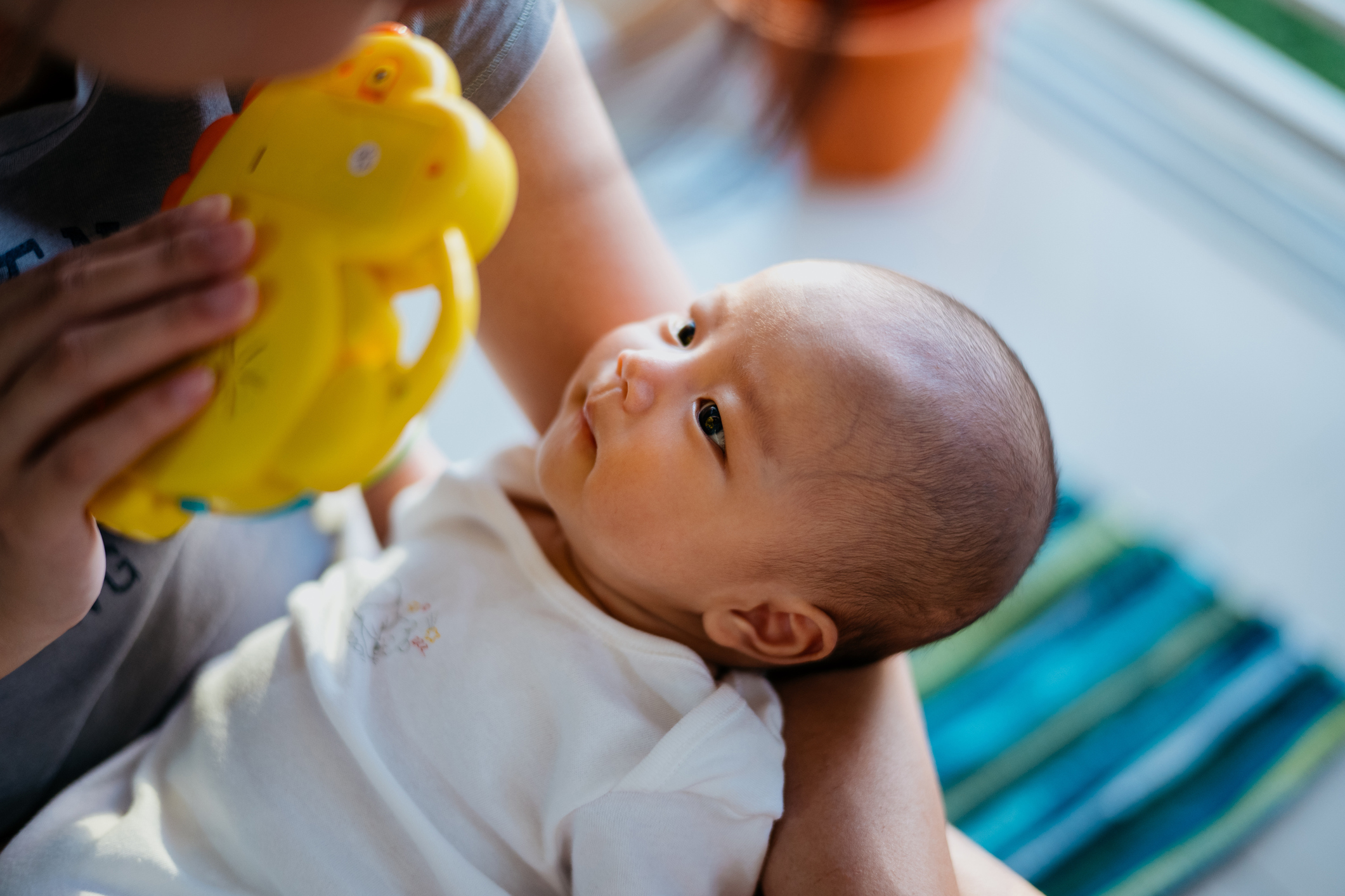 Asian mother playing with her baby at home