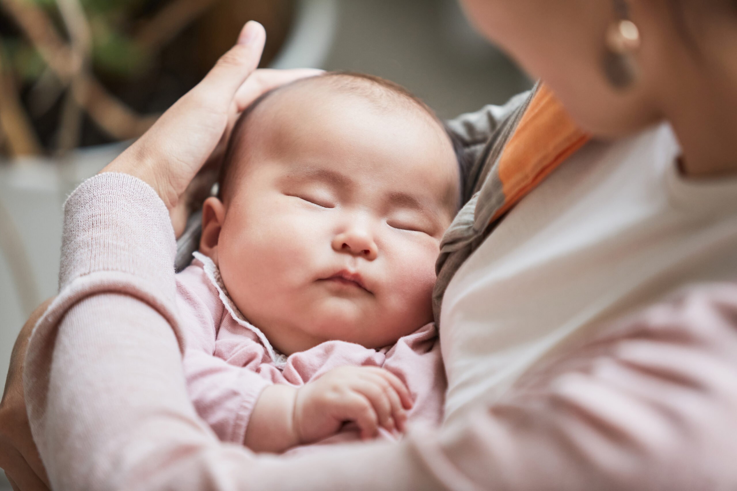Mother holding her sleeping child