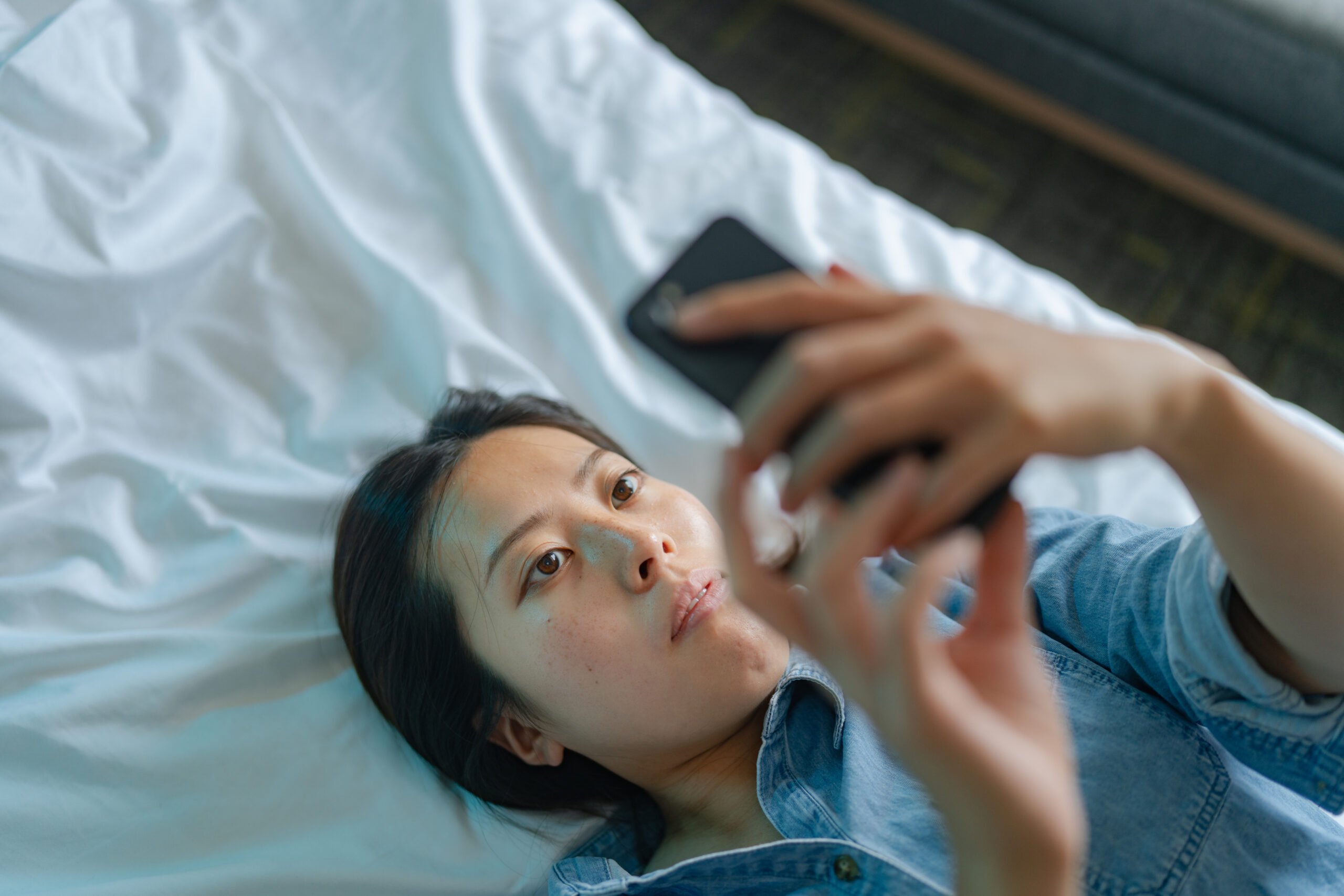 sad woman looking at phone