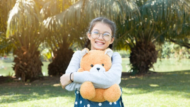 girl hugging teddy bear