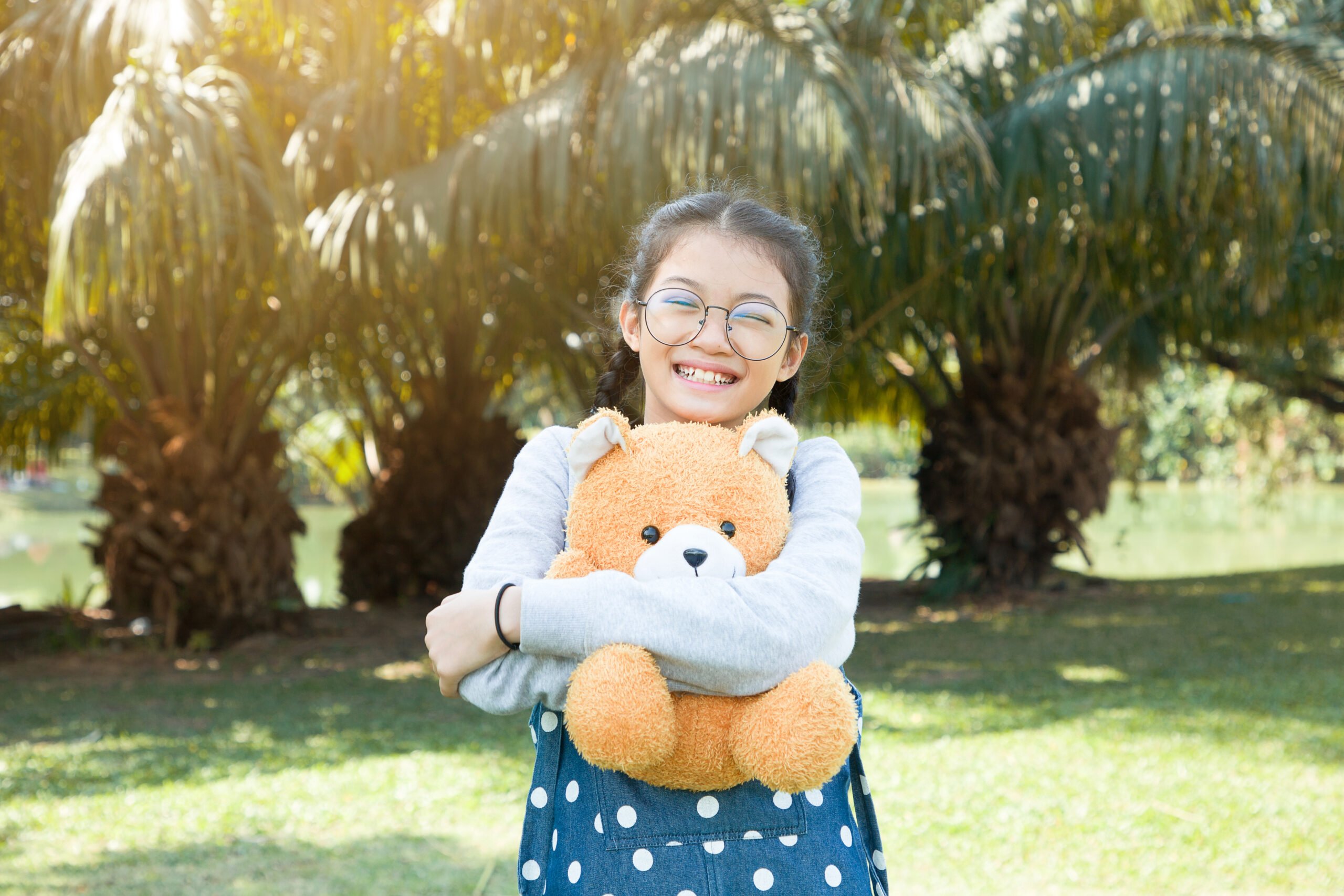 girl hugging teddy bear