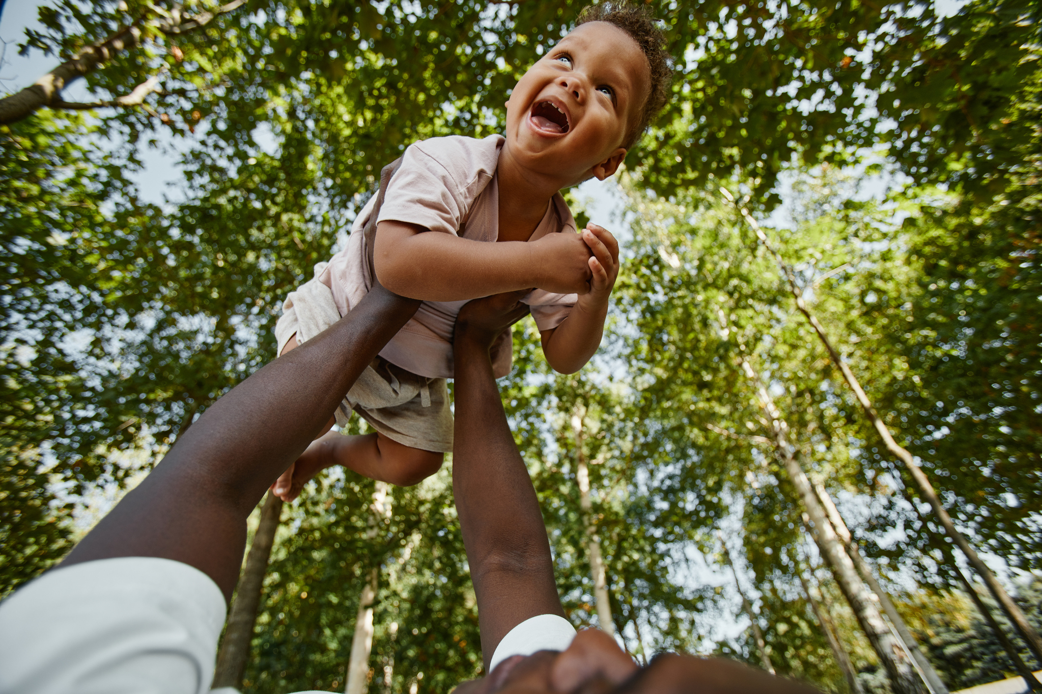 Happy Baby Playing with Dad in Park