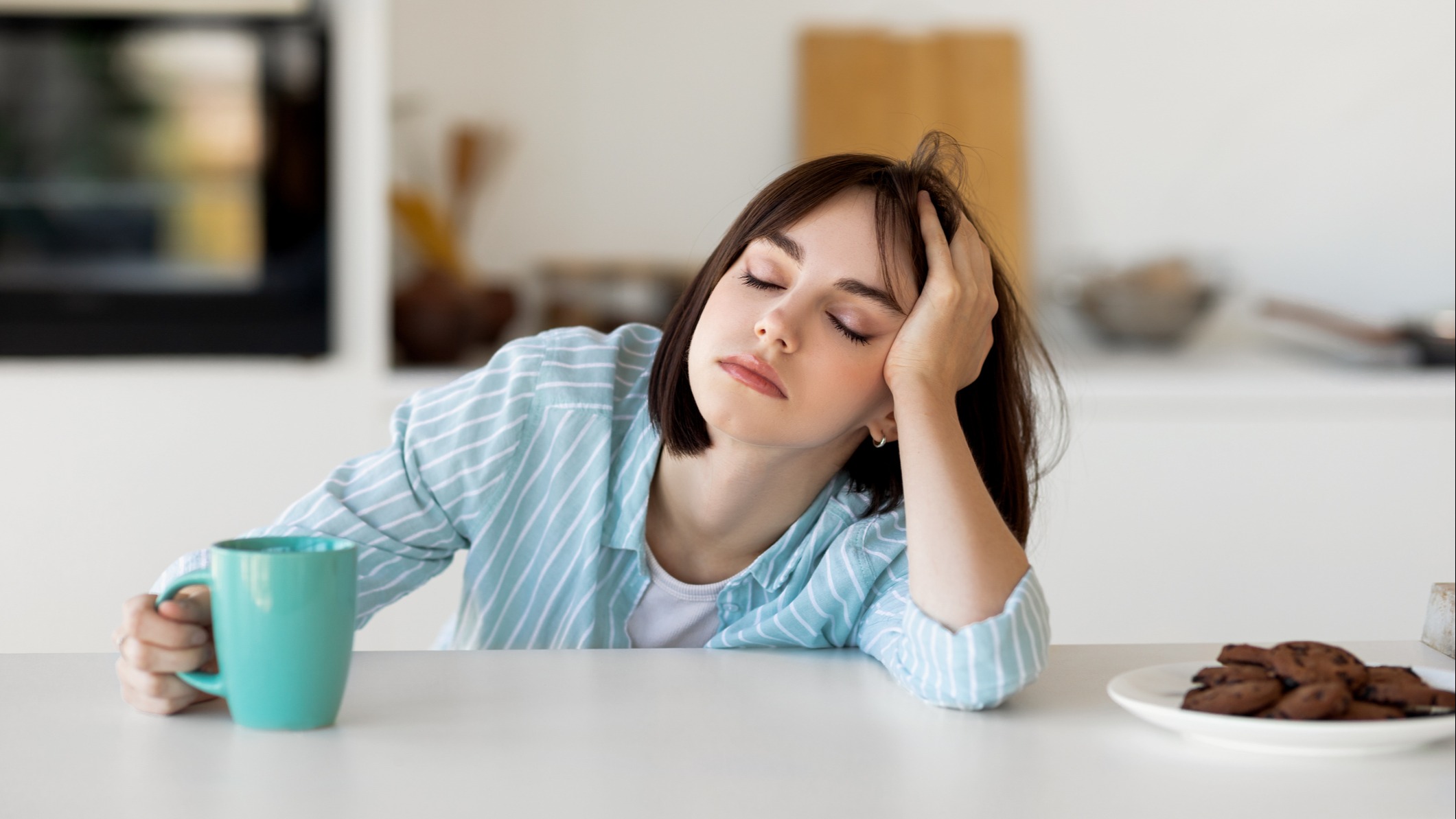 A woman sitting at her desk tired