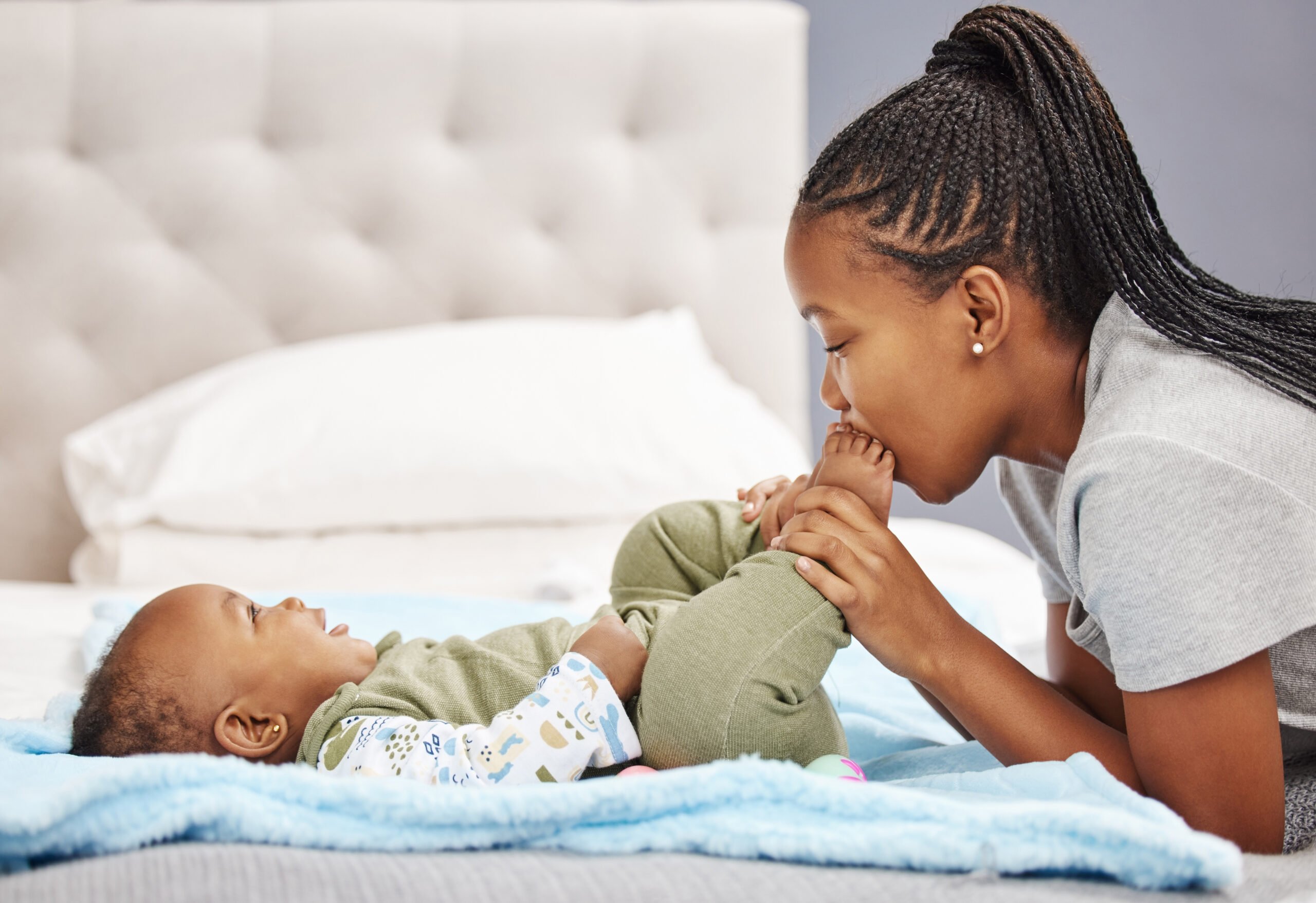 Shot of a woman bonding with her baby at home