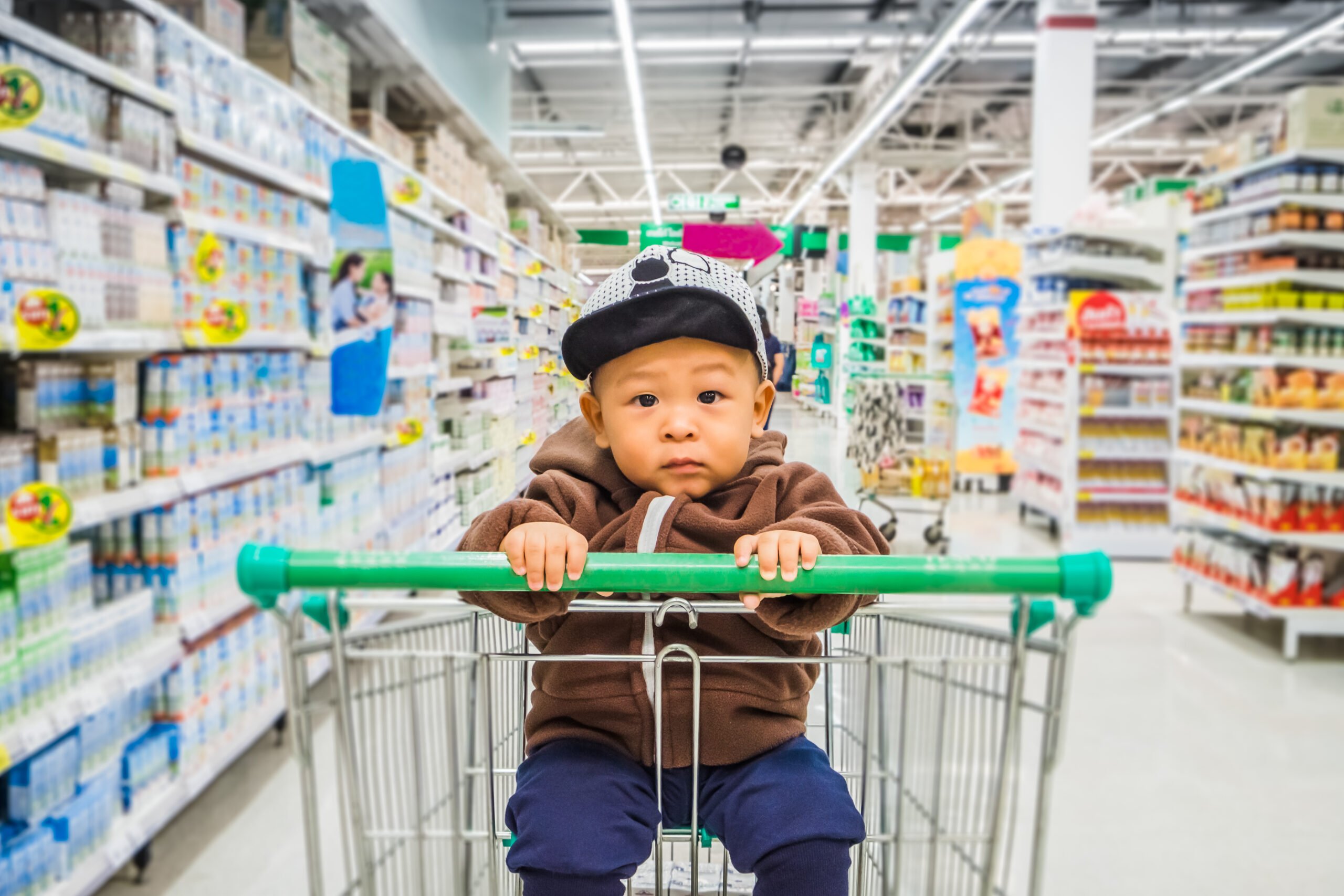 Little Asian baby boy enjoy shopping in the supermarket