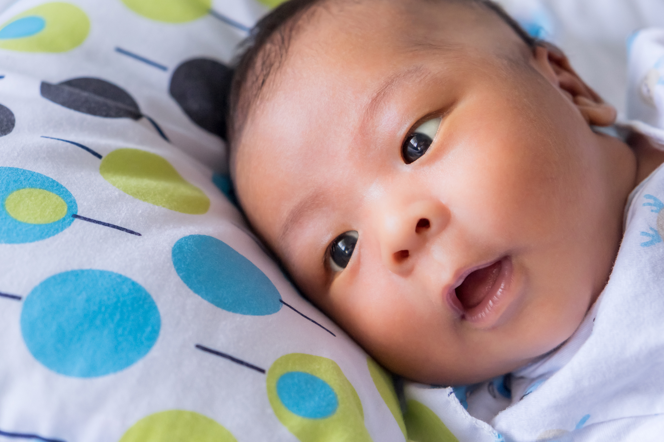 Relaxing cute Asian newborn baby boy lying fast sleeping