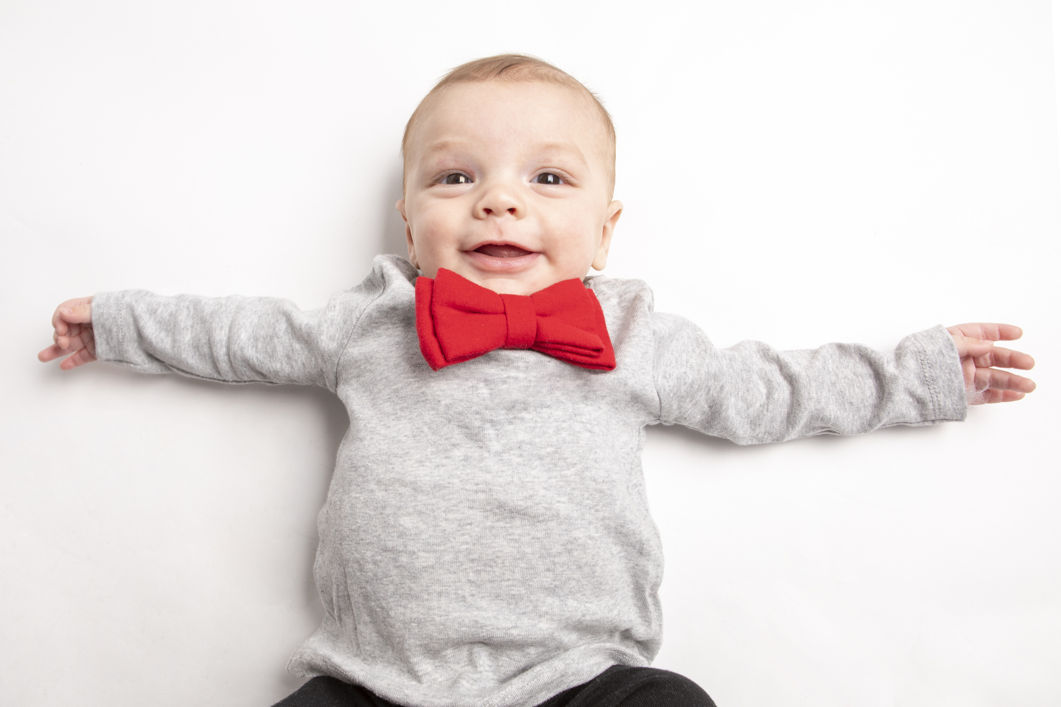 Smiling Five Month Old Baby Boy in Red Bow Tie