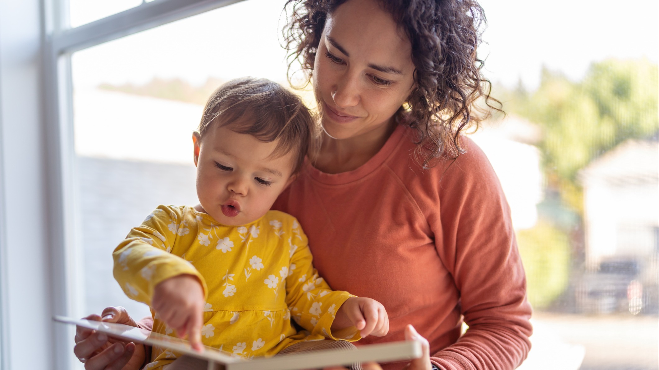 A mom reading to her son