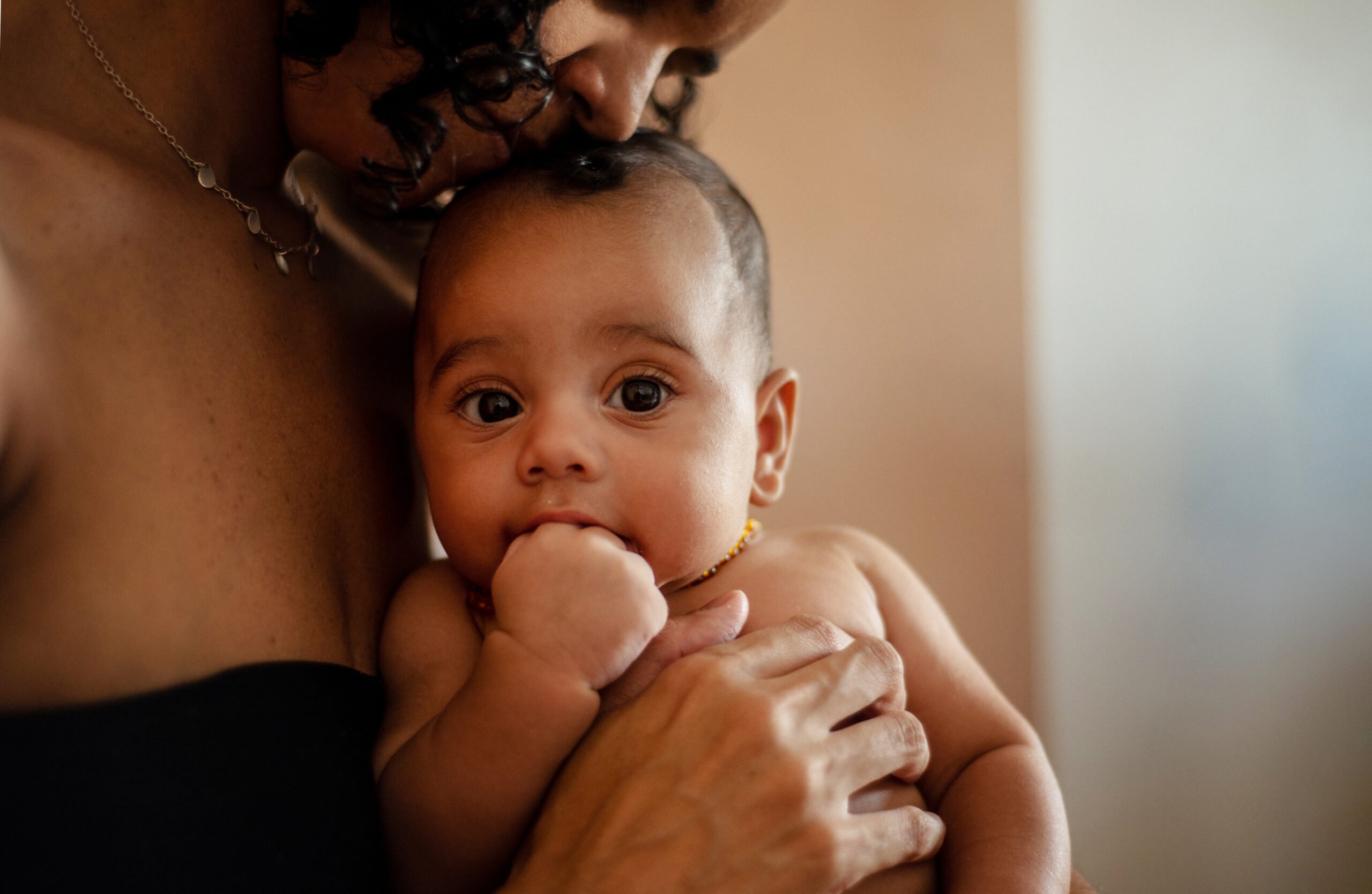 Mother with baby on her lap. Space for text.