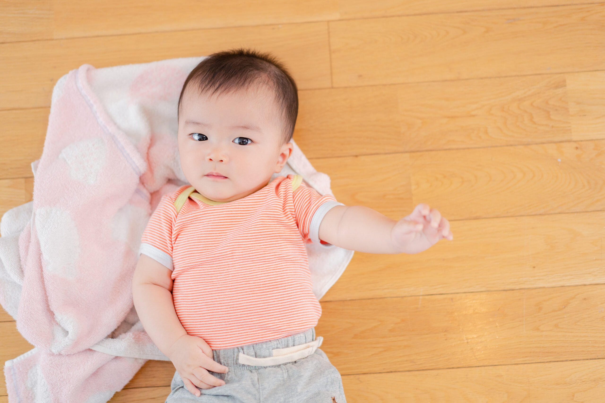 Baby lying on the floor of your house