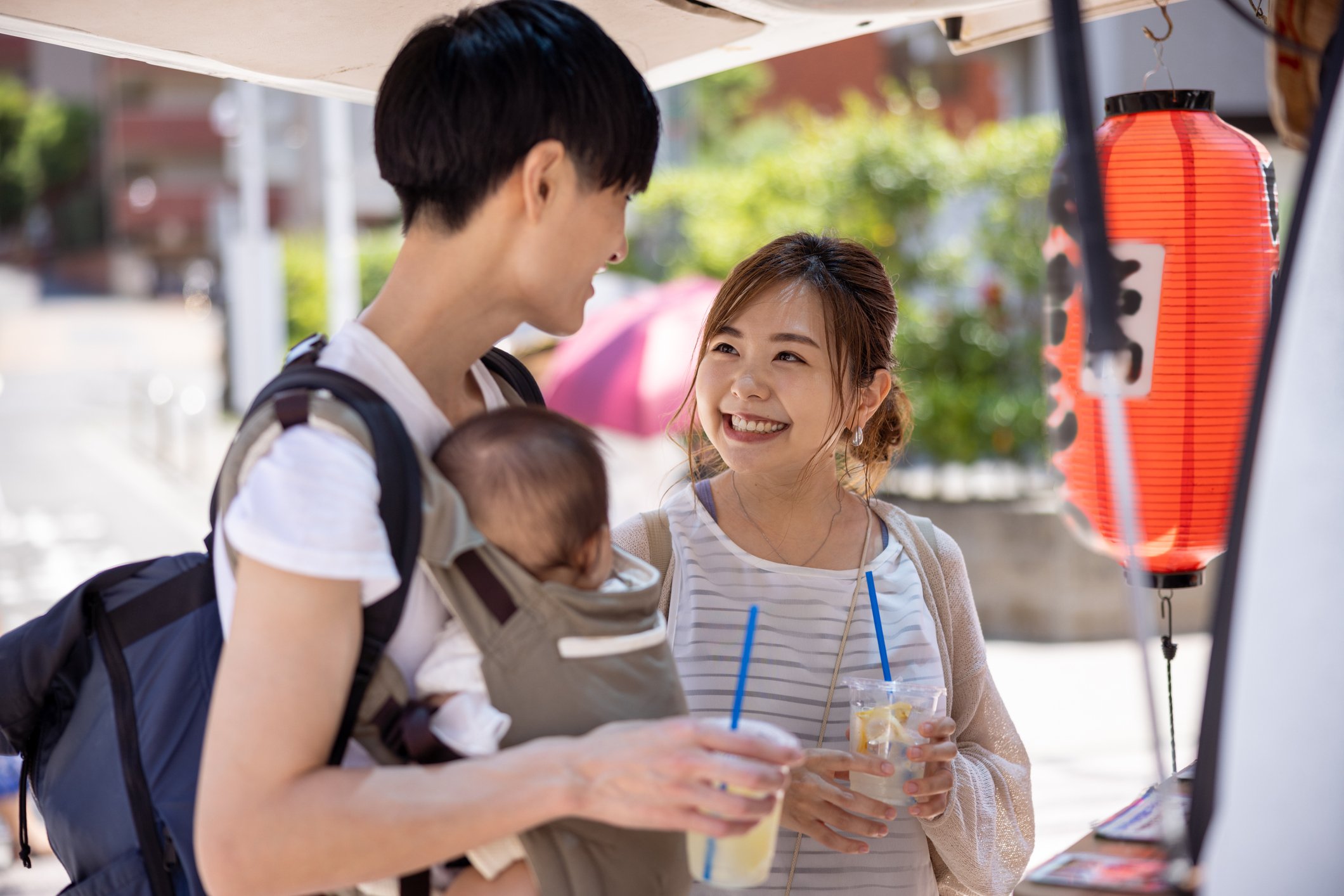 Happy family looking at each other in front of food stall