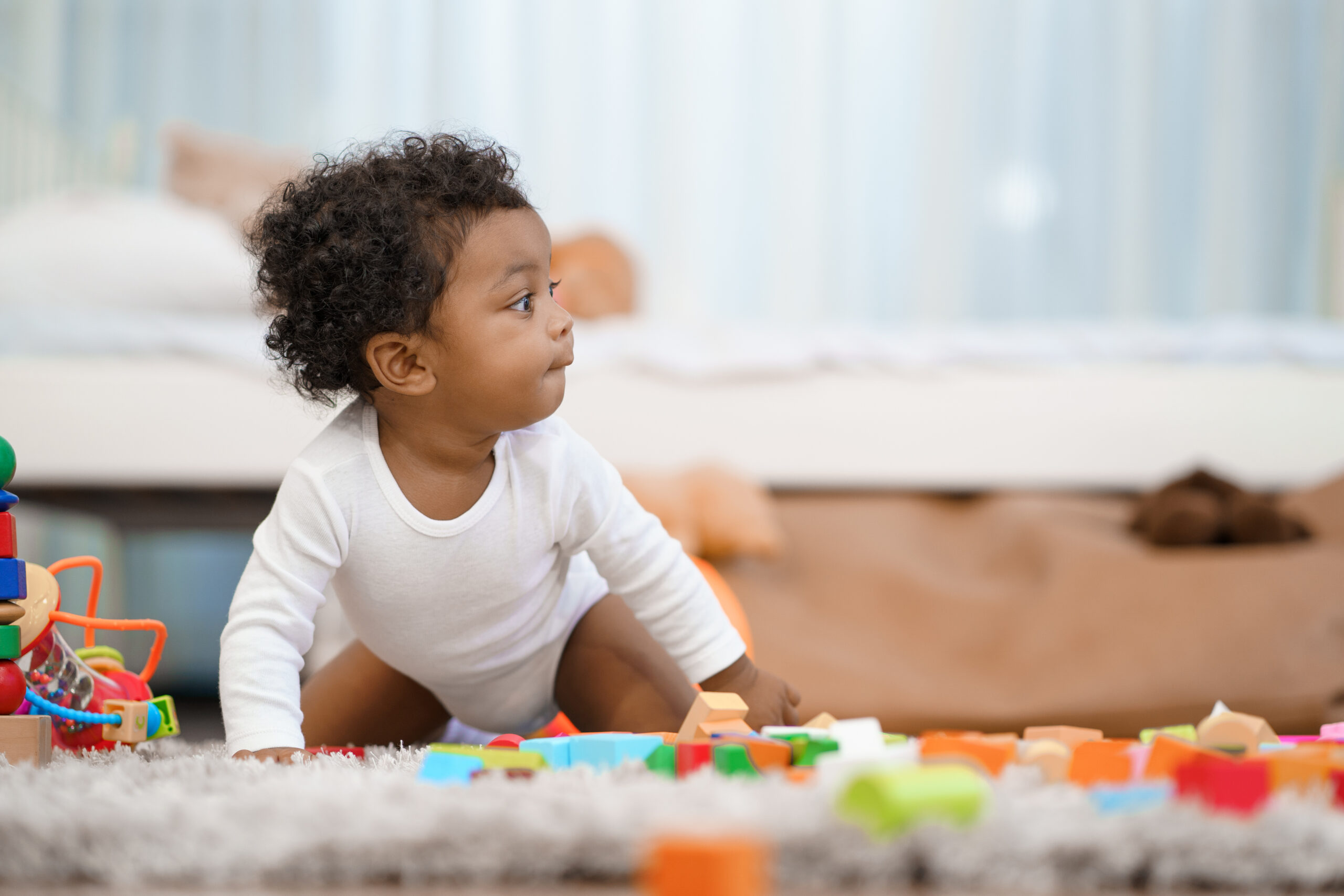 Happy African American Little baby boy crawling and looking for some thing to learn