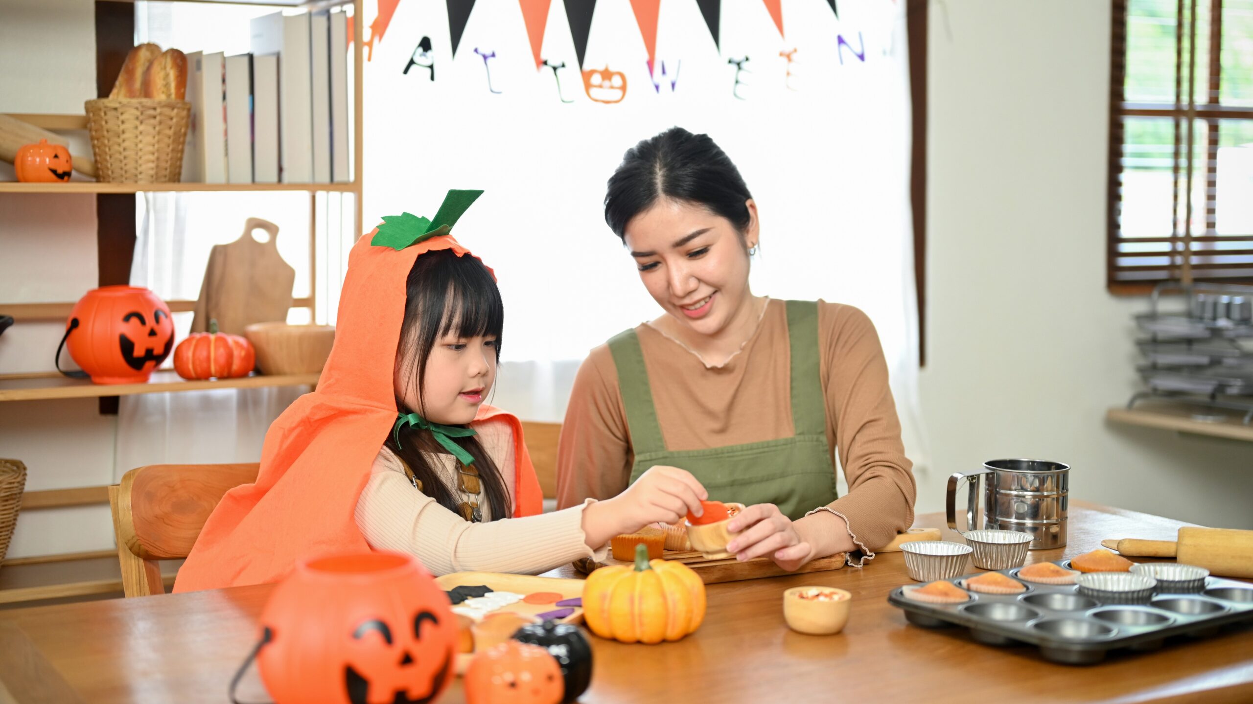 mom and kid doing crafts halloween