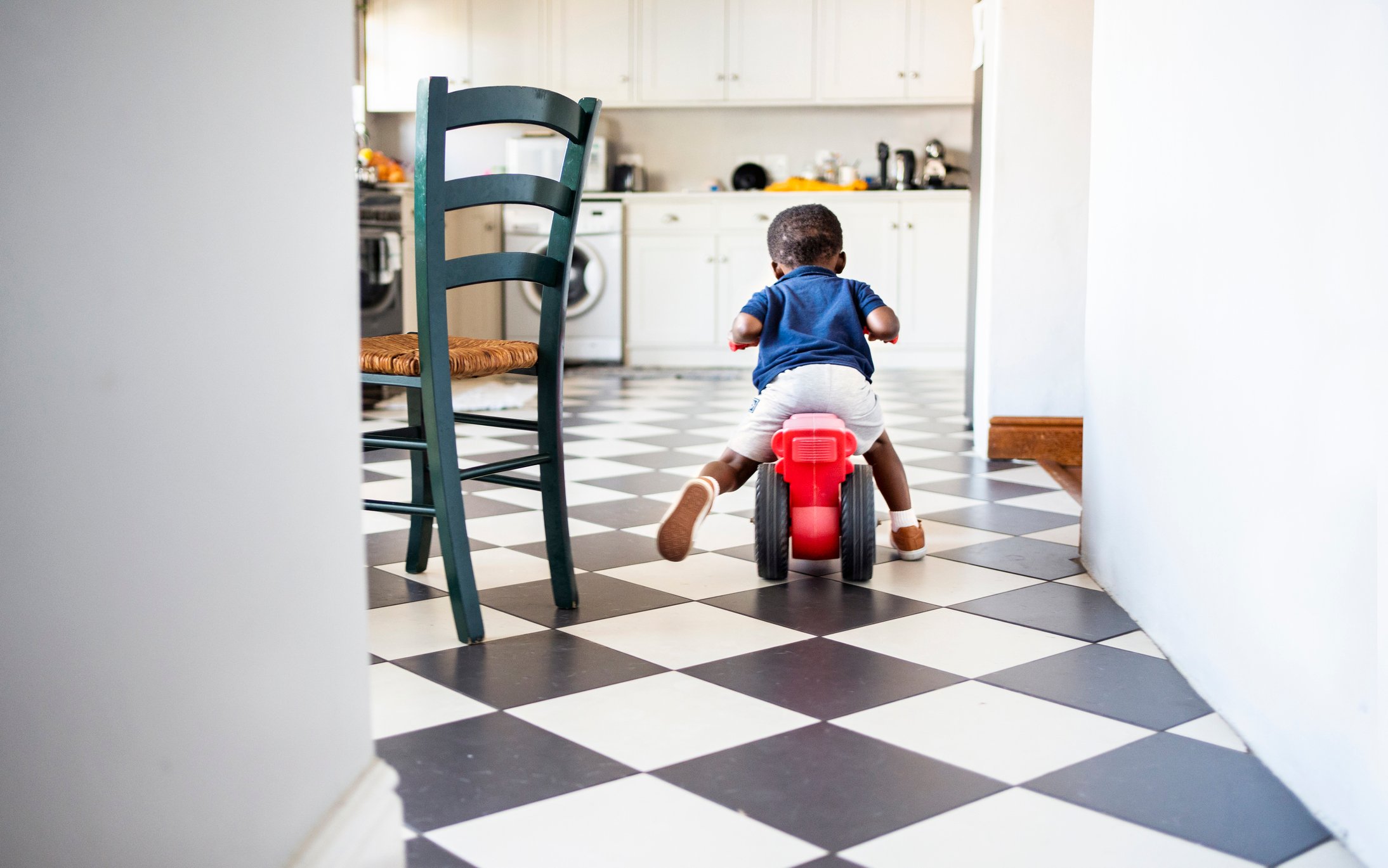 A kid riding on a toy